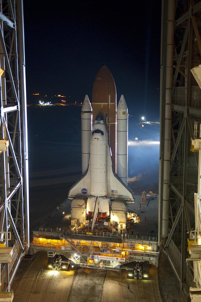 CAPE CANAVERAL, Fla. -- Bathed in xenon lights, space shuttle Endeavour, attached to its external fuel tank and solid rocket boosters, rolls out of the Vehicle Assembly Building on a nighttime journey to Launch Pad 39A at NASA's Kennedy Space Center in Florida. The 3.4-mile trek, known as "rollout," began at 7:56 p.m. EST and will take about seven hours to complete. This is the final scheduled rollout for Endeavour, which is attached to its external fuel tank and solid rocket boosters atop a crawler-transporter. Endeavour and its six STS-134 crew members will deliver the Express Logistics Carrier-3, Alpha Magnetic Spectrometer-2 (AMS), a high-pressure gas tank, additional spare parts for the Dextre robotic helper and micrometeoroid debris shields to the International Space Station on the shuttle's final spaceflight. Launch is targeted for April 19 at 7:48 p.m. EDT. For more information visit, www.nasa.gov/mission_pages/shuttle/shuttlemissions/sts134/index.html. Photo credit: NASA/Jim Grossmann