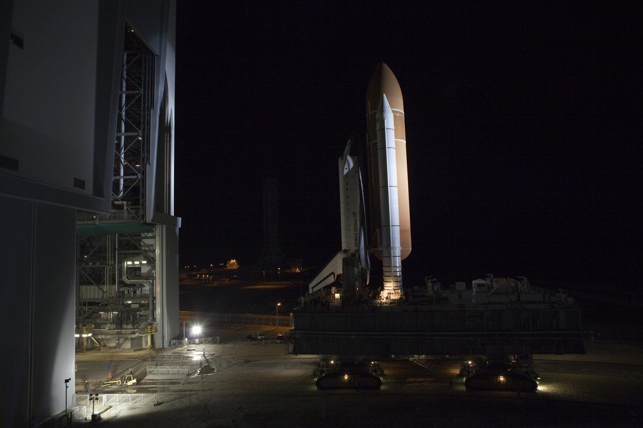 CAPE CANAVERAL, Fla. -- Space shuttle Endeavour moves through a high bay door of the Vehicle Assembly Building to begin its nighttime journey to Launch Pad 39A at NASA's Kennedy Space Center in Florida.     Riding atop a crawler-transporter attached to its external fuel tank and solid rocket boosters, Endeavour's 3.4-mile trek, known as "rollout," began at 7:56 p.m. EST and will take about seven hours to complete. This is the final scheduled rollout for Endeavour.  Endeavour and its six-member crew will deliver the Express Logistics Carrier-3, Alpha Magnetic Spectrometer-2 (AMS), a high-pressure gas tank, additional spare parts for the Dextre robotic helper and micrometeoroid debris shields to the International Space Station on the shuttle's final spaceflight, STS-134. Launch is targeted for 7:48 p.m. EDT April 19. For more information, visit www.nasa.gov/mission_pages/shuttle/shuttlemissions/sts134/index.html. Photo credit: NASA/Terry Zaperach