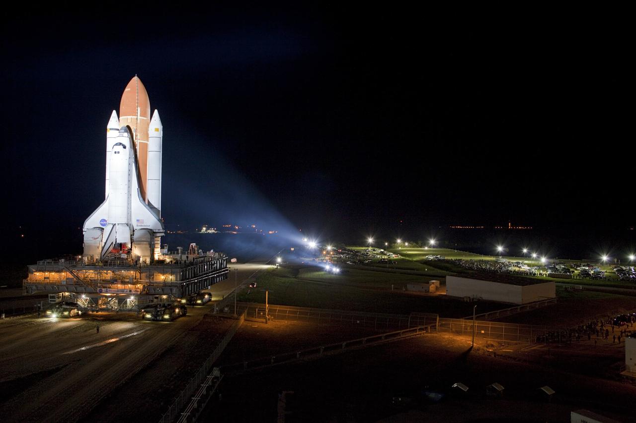 CAPE CANAVERAL, Fla. -- Space shuttle Endeavour basks in the xenon spotlights on its nighttime journey from the Vehicle Assembly Building to Launch Pad 39A at NASA's Kennedy Space Center in Florida.     Riding atop a crawler-transporter attached to its external fuel tank and solid rocket boosters, Endeavour's 3.4-mile trek, known as "rollout," began at 7:56 p.m. EST and will take about seven hours to complete. This is the final scheduled rollout for Endeavour.  Endeavour and its six-member crew will deliver the Express Logistics Carrier-3, Alpha Magnetic Spectrometer-2 (AMS), a high-pressure gas tank, additional spare parts for the Dextre robotic helper and micrometeoroid debris shields to the International Space Station on the shuttle's final spaceflight, STS-134. Launch is targeted for 7:48 p.m. EDT April 19. For more information, visit www.nasa.gov/mission_pages/shuttle/shuttlemissions/sts134/index.html. Photo credit: NASA/Terry Zaperach