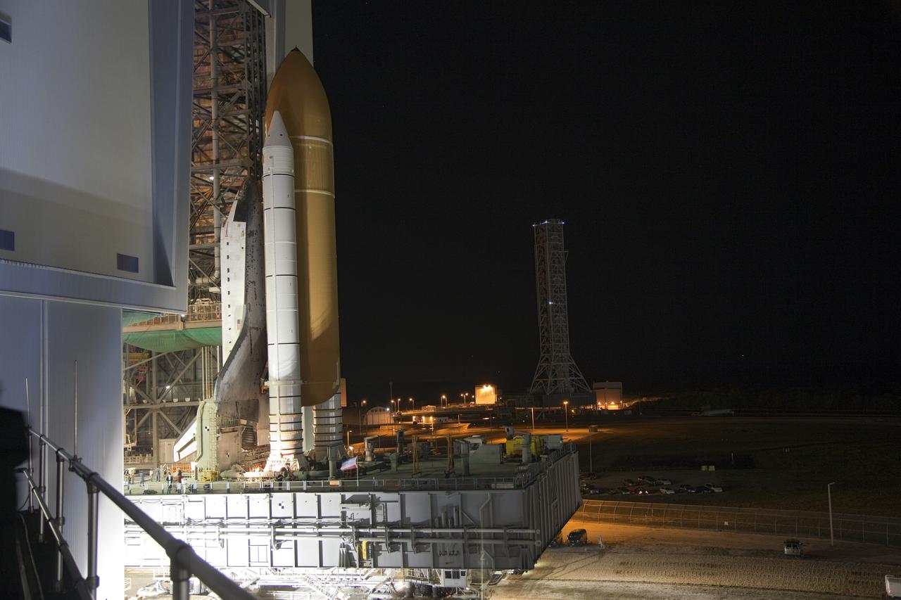 CAPE CANAVERAL, Fla. -- Space shuttle Endeavour moves through a high bay door of the Vehicle Assembly Building on its mobile launch platform to begin its nighttime journey to Launch Pad 39A at NASA's Kennedy Space Center in Florida.     Riding atop a crawler-transporter attached to its external fuel tank and solid rocket boosters, Endeavour's 3.4-mile trek, known as "rollout," began at 7:56 p.m. EST and will take about seven hours to complete. This is the final scheduled rollout for Endeavour.  Endeavour and its six-member crew will deliver the Express Logistics Carrier-3, Alpha Magnetic Spectrometer-2 (AMS), a high-pressure gas tank, additional spare parts for the Dextre robotic helper and micrometeoroid debris shields to the International Space Station on the shuttle's final spaceflight, STS-134. Launch is targeted for 7:48 p.m. EDT April 19. For more information, visit www.nasa.gov/mission_pages/shuttle/shuttlemissions/sts134/index.html. Photo credit: NASA/Frankie Martin