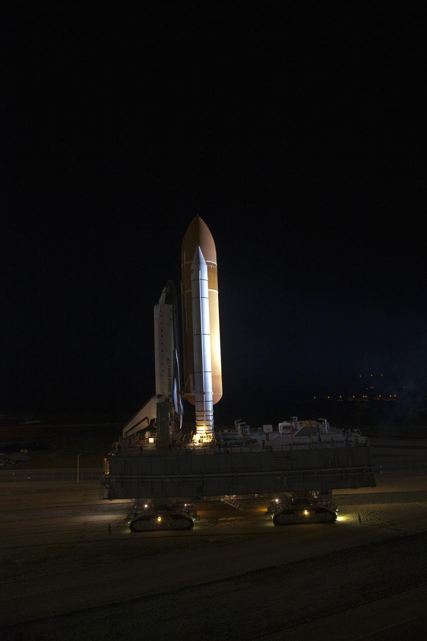 CAPE CANAVERAL, Fla. -- Space shuttle Endeavour, secured on its mobile launcher platform, pulls away from the Vehicle Assembly Building for its nighttime journey to Launch Pad 39A at NASA's Kennedy Space Center in Florida.     Riding atop a crawler-transporter attached to its external fuel tank and solid rocket boosters, Endeavour's 3.4-mile trek, known as "rollout," began at 7:56 p.m. EST and will take about seven hours to complete. This is the final scheduled rollout for Endeavour.  Endeavour and its six-member crew will deliver the Express Logistics Carrier-3, Alpha Magnetic Spectrometer-2 (AMS), a high-pressure gas tank, additional spare parts for the Dextre robotic helper and micrometeoroid debris shields to the International Space Station on the shuttle's final spaceflight, STS-134. Launch is targeted for 7:48 p.m. EDT April 19. For more information, visit www.nasa.gov/mission_pages/shuttle/shuttlemissions/sts134/index.html. Photo credit: NASA/Frankie Martin