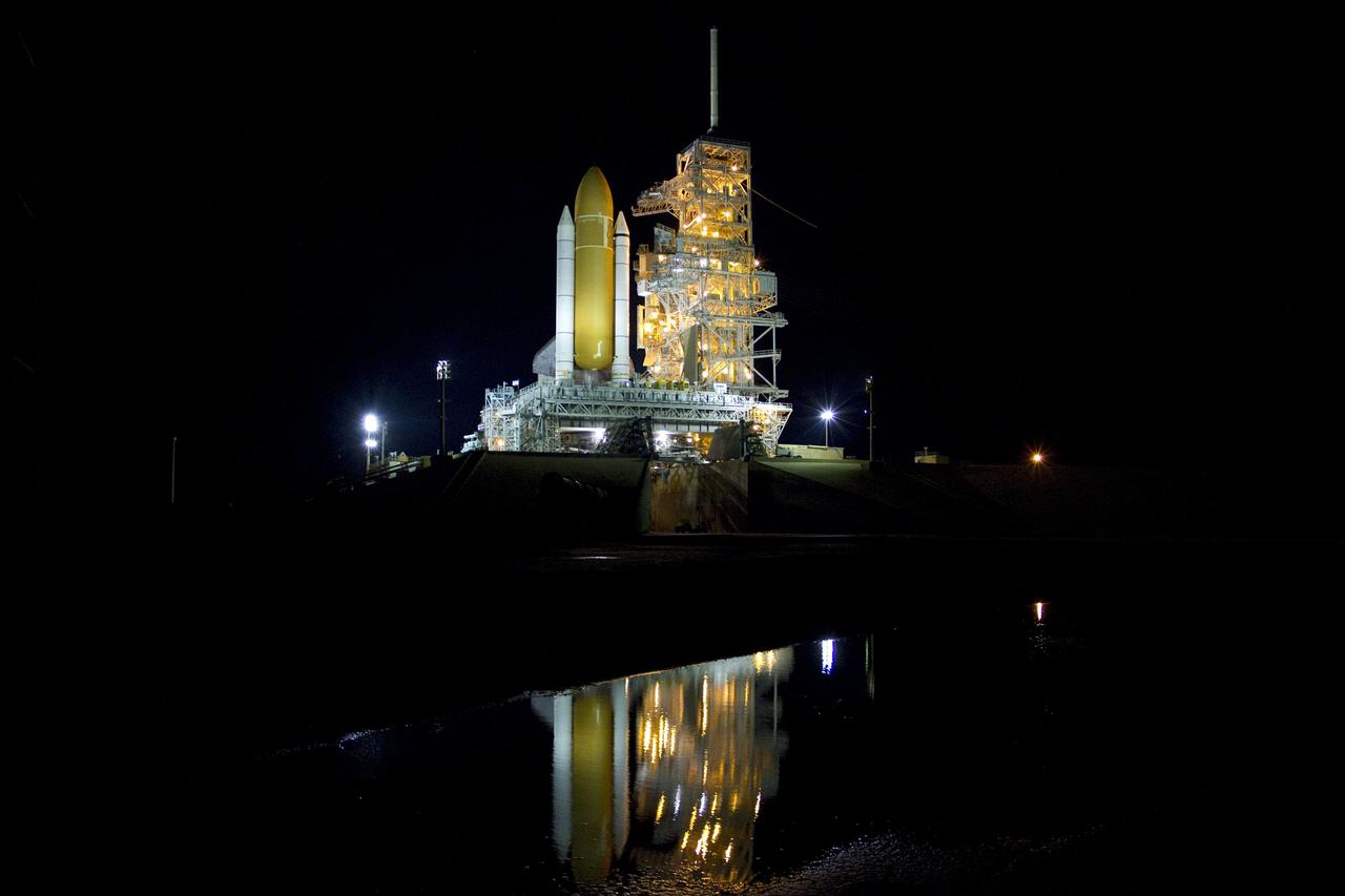 CAPE CANAVERAL, Fla. -- The newly arrived space shuttle Endeavour is reflected in the water near Launch Pad 39A at NASA's Kennedy Space Center in Florida.    Riding atop a crawler-transporter attached to its external fuel tank and solid rocket boosters, Endeavour's 3.4-mile trek, known as "rollout," began at the Vehicle Assembly Building at 7:56 p.m. EST March 10 and ended at 3:49 a.m. EST, nearly eight hours later. This is Endeavour's final scheduled rollout.  Endeavour and its six-member crew will deliver the Express Logistics Carrier-3, Alpha Magnetic Spectrometer-2 (AMS), a high-pressure gas tank, additional spare parts for the Dextre robotic helper and micrometeoroid debris shields to the International Space Station on the shuttle's final spaceflight, STS-134. Launch is targeted for 7:48 p.m. EDT April 19. For more information, visit www.nasa.gov/mission_pages/shuttle/shuttlemissions/sts134/index.html. Photo credit: NASA/Jack Pfaller