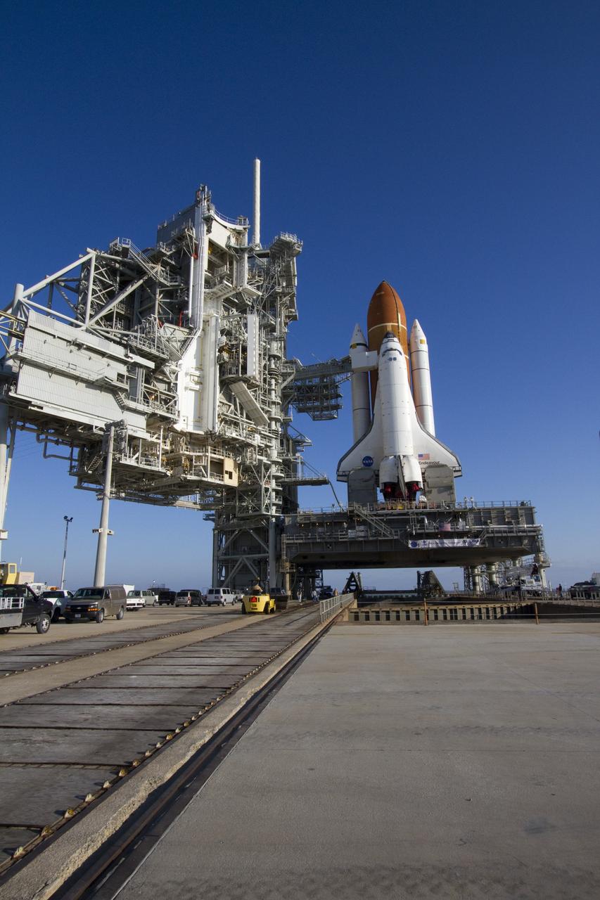 CAPE CANAVERAL, Fla. -- Space shuttle Endeavour stands ready for processing beside the rotating and fixed service structures on Launch Pad 39A at NASA's Kennedy Space Center in Florida.     Riding atop a crawler-transporter attached to its external fuel tank and solid rocket boosters, Endeavour's 3.4-mile trek, known as "rollout," began at the Vehicle Assembly Building at 7:56 p.m. EST March 10 and ended at 3:49 a.m. EST, nearly eight hours later. This is Endeavour's final scheduled rollout.  Endeavour and its six-member crew will deliver the Express Logistics Carrier-3, Alpha Magnetic Spectrometer-2 (AMS), a high-pressure gas tank, additional spare parts for the Dextre robotic helper and micrometeoroid debris shields to the International Space Station on the shuttle's final spaceflight, STS-134. Launch is targeted for 7:48 p.m. EDT April 19. For more information, visit www.nasa.gov/mission_pages/shuttle/shuttlemissions/sts134/index.html. Photo credit: NASA/Jack Pfaller