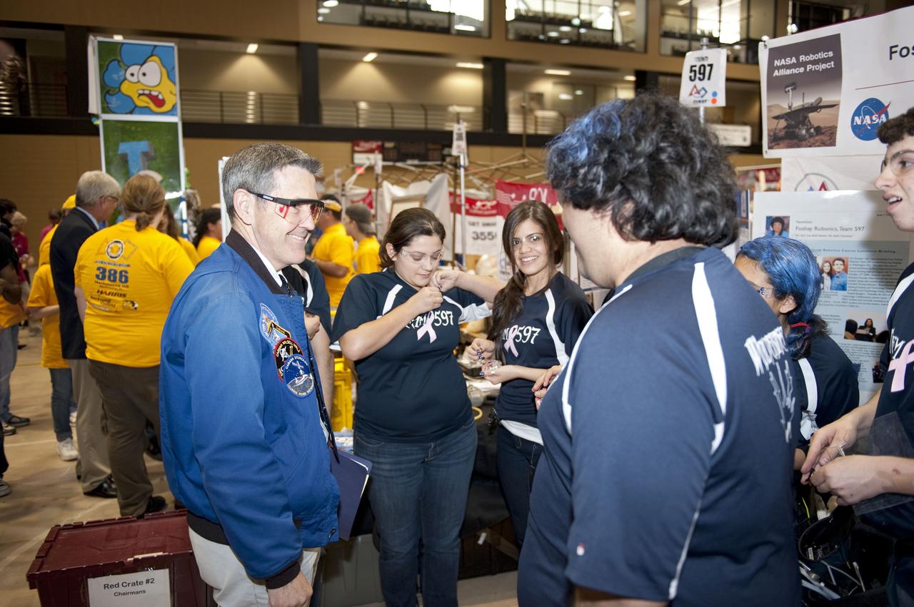 ORLANDO, Fla. – NASA Kennedy Space Center Director Bob Cabana talks to The Wolverines team at the regional FIRST robotics competition at the University of Central Florida in Orlando. The team is made up of students from the Foshay Learning Center located in Los Angeles. NASA is a sponsor of the team. About 60 high school teams took part in the competition called "For Inspiration and Recognition of Science and Technology," or FIRST, in hopes of advancing to the national robotics championship. The team took home the Industrial Safety Award sponsored by Underwriters Laboratories. FIRST, founded in 1989, is a non-profit organization that designs accessible, innovative programs to build self-confidence, knowledge and life skills while motivating young people to pursue academic opportunities. The robotics competition challenges teams of high school students and their mentors to solve a common problem in a six-week timeframe using a standard kit of parts and a common set of rules. Photo credit: NASA/Glenn Benson