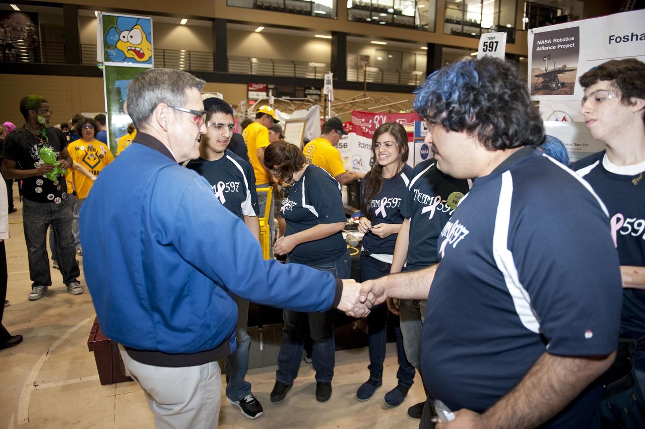 ORLANDO, Fla. – NASA Kennedy Space Center Director Bob Cabana talks to The Wolverines team at the regional FIRST robotics competition at the University of Central Florida in Orlando. The team is made up of students from the Foshay Learning Center located in Los Angeles. NASA is a sponsor of the team. About 60 high school teams took part in the competition called "For Inspiration and Recognition of Science and Technology," or FIRST, in hopes of advancing to the national robotics championship. The team took home the Industrial Safety Award sponsored by Underwriters Laboratories. FIRST, founded in 1989, is a non-profit organization that designs accessible, innovative programs to build self-confidence, knowledge and life skills while motivating young people to pursue academic opportunities. The robotics competition challenges teams of high school students and their mentors to solve a common problem in a six-week timeframe using a standard kit of parts and a common set of rules. Photo credit: NASA/Glenn Benson