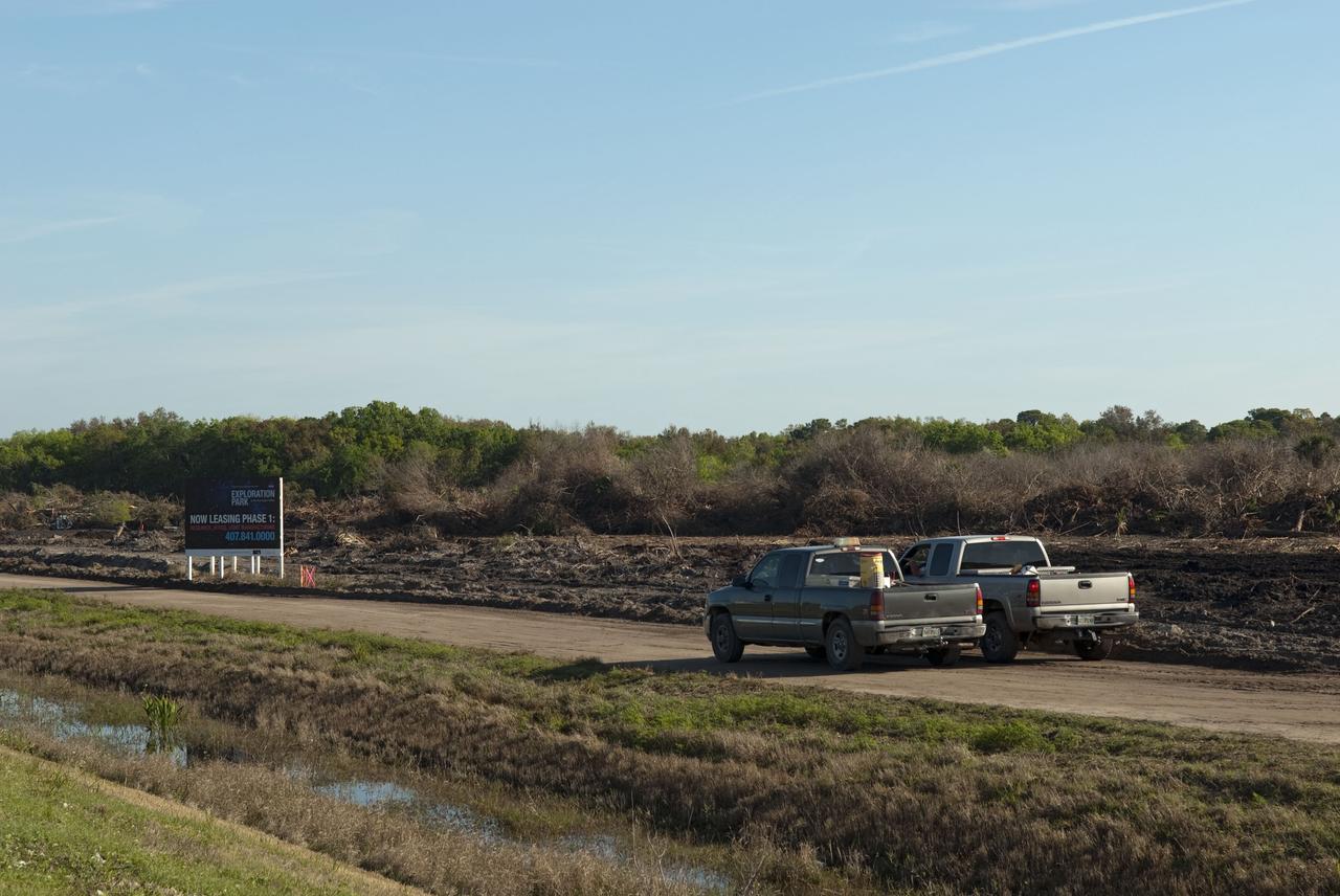 CAPE CANAVERAL, Fla. -- Land clearing and construction of a new road at the Exploration Park site begins outside of the Space Life Sciences Laboratory (SLSL) at NASA's Kennedy Space Center in Florida. The fill dirt being used to develop the first phase was donated by Port Canaveral as part of an agreement between the port and Space Florida, the park’s partner developer. The first phase will encompass 60 acres just outside Kennedy’s security gates. Nine buildings will provide 350,000-square feet of work space, including educational, office, research and lab, and high-bay facilities. Each building is expected to be certified in the U.S. Green Building Council’s Leadership in Environmental and Energy Design (LEED).Exploration Park is designed to be a strategically located complex, adjacent to the SLSL, for servicing diverse tenants and uses that will engage in activities to support space-related activities of NASA, other government agencies and the U.S. commercial space industry. It also is expected to bring new aerospace work to the Space Coast. The SLSL will be the anchor facility for the park, which is expected to open its first new facility in early 2012. Photo credit: NASA/Jim Grossmann