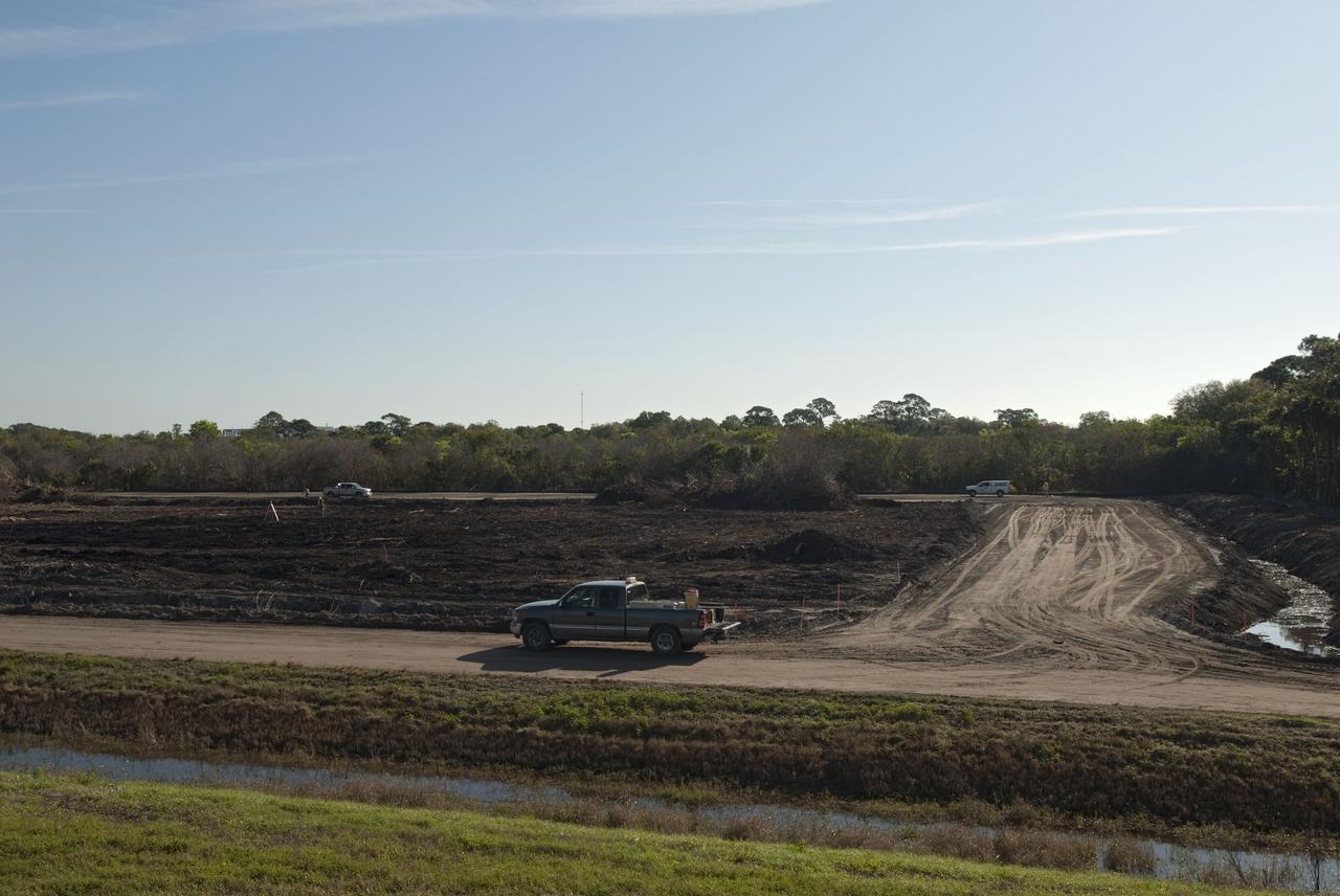 CAPE CANAVERAL, Fla. -- Land clearing and construction of a new road at the Exploration Park site begins outside of the Space Life Sciences Laboratory (SLSL) at NASA's Kennedy Space Center in Florida. The fill dirt being used to develop the first phase was donated by Port Canaveral as part of an agreement between the port and Space Florida, the park’s partner developer. The first phase will encompass 60 acres just outside Kennedy’s security gates. Nine buildings will provide 350,000-square feet of work space, including educational, office, research and lab, and high-bay facilities. Each building is expected to be certified in the U.S. Green Building Council’s Leadership in Environmental and Energy Design (LEED).Exploration Park is designed to be a strategically located complex, adjacent to the SLSL, for servicing diverse tenants and uses that will engage in activities to support space-related activities of NASA, other government agencies and the U.S. commercial space industry. It also is expected to bring new aerospace work to the Space Coast. The SLSL will be the anchor facility for the park, which is expected to open its first new facility in early 2012. Photo credit: NASA/Jim Grossmann