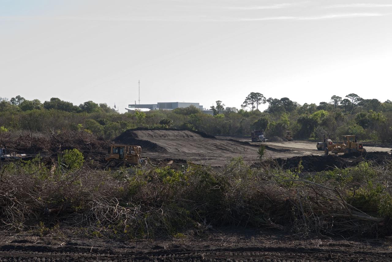 CAPE CANAVERAL, Fla. -- Land clearing and construction of a new road at the Exploration Park site begins outside of the Space Life Sciences Laboratory (SLSL) at NASA's Kennedy Space Center in Florida. The fill dirt being used to develop the first phase was donated by Port Canaveral as part of an agreement between the port and Space Florida, the park’s partner developer. The first phase will encompass 60 acres just outside Kennedy’s security gates. Nine buildings will provide 350,000-square feet of work space, including educational, office, research and lab, and high-bay facilities. Each building is expected to be certified in the U.S. Green Building Council’s Leadership in Environmental and Energy Design (LEED).Exploration Park is designed to be a strategically located complex, adjacent to the SLSL, for servicing diverse tenants and uses that will engage in activities to support space-related activities of NASA, other government agencies and the U.S. commercial space industry. It also is expected to bring new aerospace work to the Space Coast. The SLSL will be the anchor facility for the park, which is expected to open its first new facility in early 2012. Photo credit: NASA/Jim Grossmann