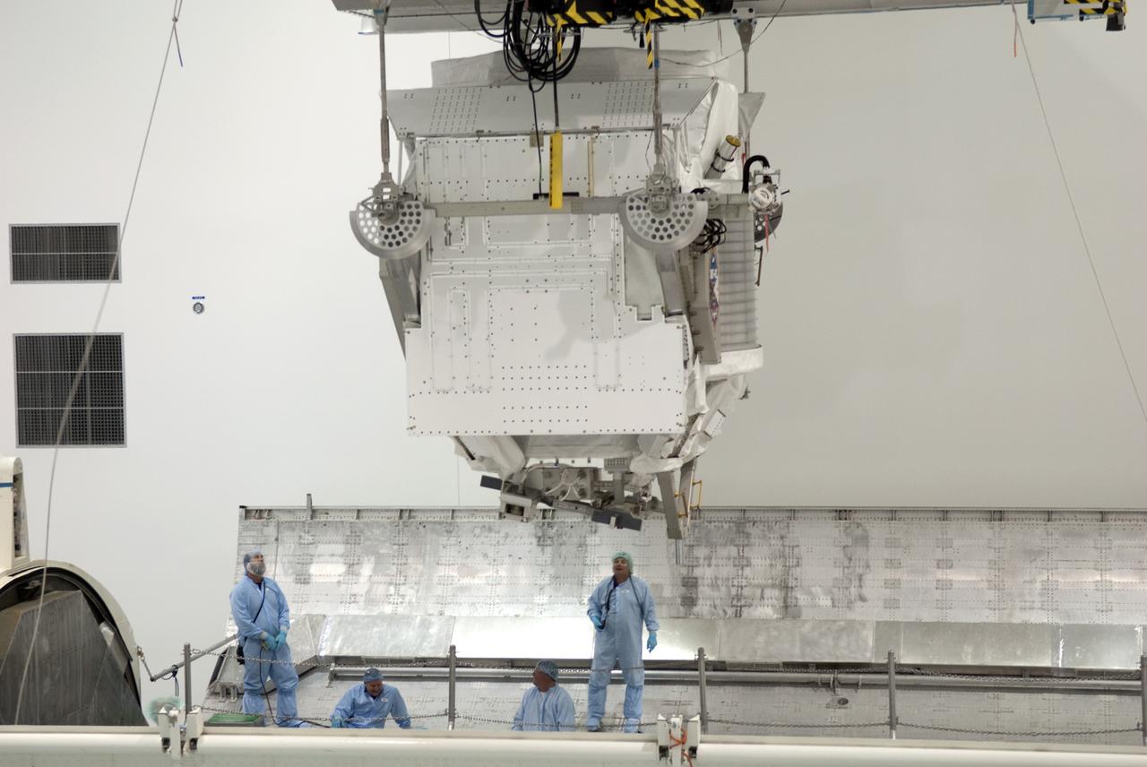 CAPE CANAVERAL, Fla. -- In the Space Station Processing Facility at NASA's Kennedy Space Center in Florida, the Alpha Magnetic Spectrometer-2 AMS is above a payload canister after technicians measured its weight and center of gravity. The canister will protect the space-bound payload on its journey to Launch Pad 39A, where it will later be installed into space shuttle Endeavour’s payload bay. AMS is a particle physics detector, designed to operate as an external experiment on the International Space Station. It will use the unique environment of space to study the universe and its origin by searching for dark matter. AMS-2 will fly to the station aboard Endeavour's STS-134 mission targeted to launch April 19 at 7:48 p.m. EDT. For more information visit, www.nasa.gov/mission_pages/shuttle/shuttlemissions/sts134/index.html. Photo credit: NASA/Jim Grossmann