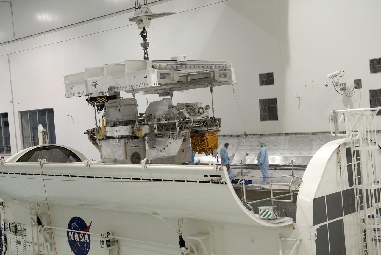 CAPE CANAVERAL, Fla. -- In the Space Station Processing Facility at NASA's Kennedy Space Center in Florida, Express Logistics Carrier-3 is lowered into a payload canister. The canister will protect the space-bound payload on its journey to Launch Pad 39A, where it will later be installed into space shuttle Endeavour’s payload bay. ELC-3 is packed with a variety of spare parts for the International Space Station, including two S-band communications antennas, a high-pressure gas tank, additional spare parts for Dextre and micrometeoroid debris shields. ELC-3 will fly to the station aboard Endeavour's STS-134 mission targeted to launch April 19 at 7:48 p.m. EDT. For more information visit, www.nasa.gov/mission_pages/shuttle/shuttlemissions/sts134/index.html. Photo credit: NASA/Jim Grossmann