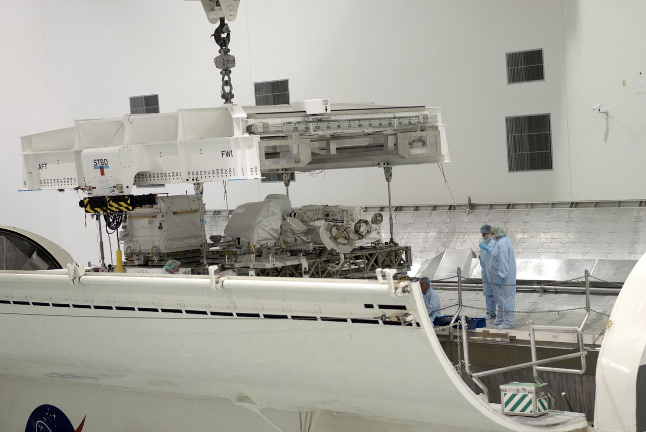 CAPE CANAVERAL, Fla. -- In the Space Station Processing Facility at NASA's Kennedy Space Center in Florida, Express Logistics Carrier-3 is lowered into a payload canister. The canister will protect the space-bound payload on its journey to Launch Pad 39A, where it will later be installed into space shuttle Endeavour’s payload bay. ELC-3 is packed with a variety of spare parts for the International Space Station, including two S-band communications antennas, a high-pressure gas tank, additional spare parts for Dextre and micrometeoroid debris shields. ELC-3 will fly to the station aboard Endeavour's STS-134 mission targeted to launch April 19 at 7:48 p.m. EDT. For more information visit, www.nasa.gov/mission_pages/shuttle/shuttlemissions/sts134/index.html. Photo credit: NASA/Jim Grossmann