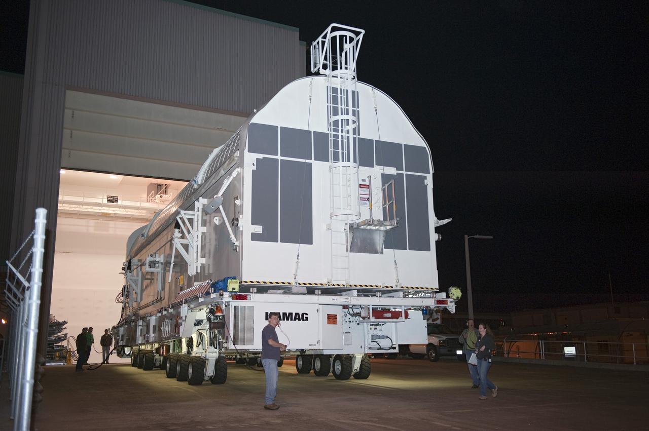 CAPE CANAVERAL, Fla. -- A canister, carrying the Alpha Magnetic Spectrometer-2 AMS and Express Logistics Carrier-3 for space shuttle Endeavour's STS-134 mission, is moved from the Space Station Processing Facility to the Canister Rotation Facility at NASA's Kennedy Space Center in Florida. There, the canister that protects the space-bound payload will be rotated from a horizontal to vertical position so that it can be installed into Endeavour's payload bay. AMS is a particle physics detector, designed to operate as an external experiment on the International Space Station. It will use the unique environment of space to study the universe and its origin by searching for dark matter. AMS-2 will fly to the station aboard Endeavour's STS-134 mission targeted to launch April 19 at 7:48 p.m. EDT. For more information visit, www.nasa.gov/mission_pages/shuttle/shuttlemissions/sts134/index.html. Photo credit: NASA/Kim Shiflett