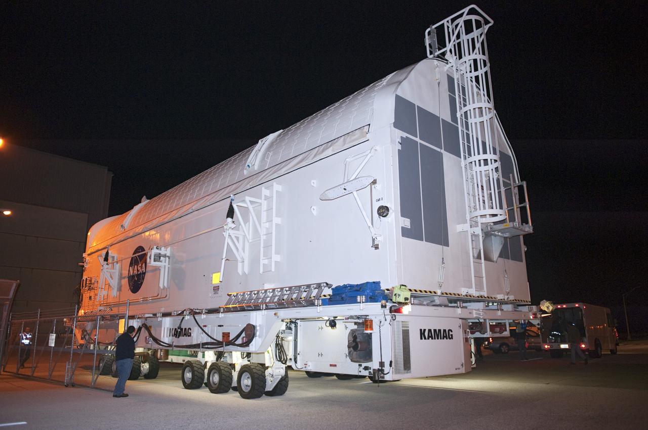 CAPE CANAVERAL, Fla. -- A canister, carrying the Alpha Magnetic Spectrometer-2 AMS and Express Logistics Carrier-3 for space shuttle Endeavour's STS-134 mission, is moved from the Space Station Processing Facility to the Canister Rotation Facility at NASA's Kennedy Space Center in Florida. There, the canister that protects the space-bound payload will be rotated from a horizontal to vertical position so that it can be installed into Endeavour's payload bay. AMS is a particle physics detector, designed to operate as an external experiment on the International Space Station. It will use the unique environment of space to study the universe and its origin by searching for dark matter. AMS-2 will fly to the station aboard Endeavour's STS-134 mission targeted to launch April 19 at 7:48 p.m. EDT. For more information visit, www.nasa.gov/mission_pages/shuttle/shuttlemissions/sts134/index.html. Photo credit: NASA/Kim Shiflett