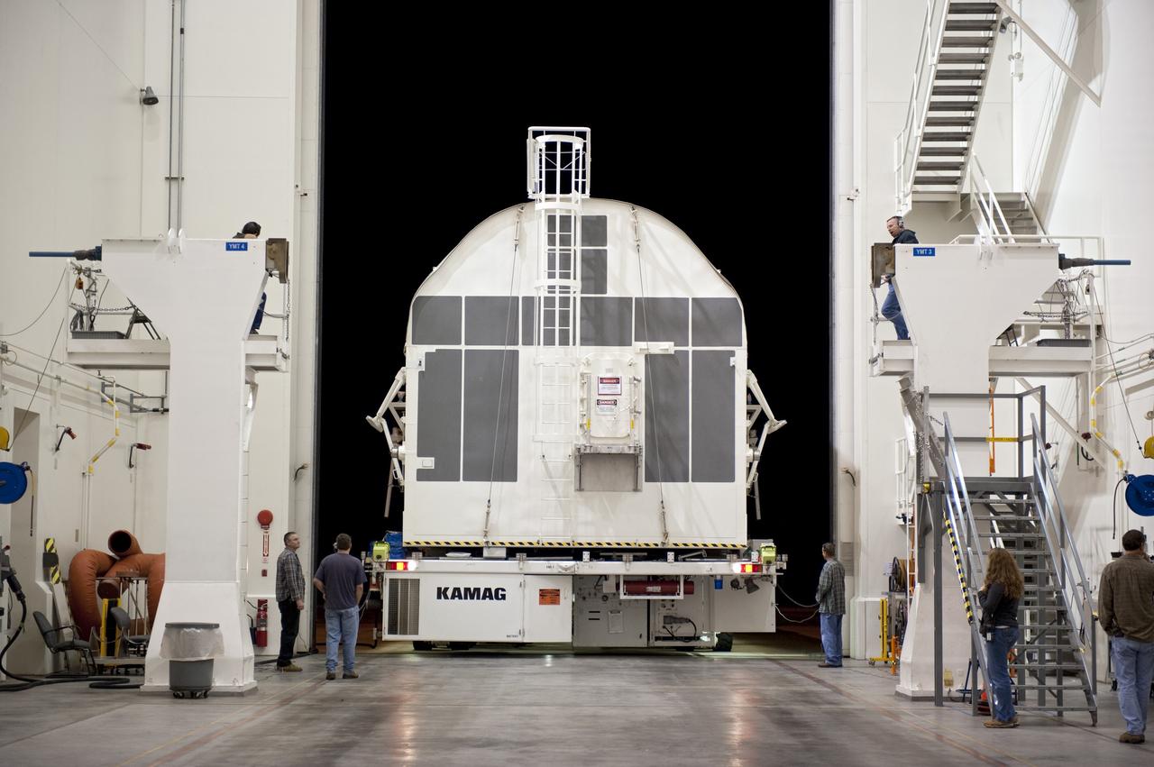 CAPE CANAVERAL, Fla. -- A canister, carrying the Alpha Magnetic Spectrometer-2 AMS and Express Logistics Carrier-3 for space shuttle Endeavour's STS-134 mission, enters the Canister Rotation Facility from the Space Station Processing Facility at NASA's Kennedy Space Center in Florida. There, the canister that protects the space-bound payload will be rotated from a horizontal to vertical position so that it can be installed into Endeavour's payload bay. AMS is a particle physics detector, designed to operate as an external experiment on the International Space Station. It will use the unique environment of space to study the universe and its origin by searching for dark matter. AMS-2 will fly to the station aboard Endeavour's STS-134 mission targeted to launch April 19 at 7:48 p.m. EDT. For more information visit, www.nasa.gov/mission_pages/shuttle/shuttlemissions/sts134/index.html. Photo credit: NASA/Kim Shiflett