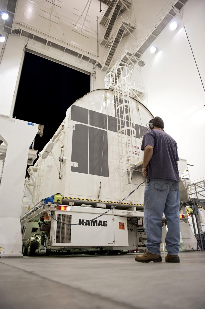 CAPE CANAVERAL, Fla. -- A canister, carrying the Alpha Magnetic Spectrometer-2 AMS and Express Logistics Carrier-3 for space shuttle Endeavour's STS-134 mission, enters the Canister Rotation Facility from the Space Station Processing Facility at NASA's Kennedy Space Center in Florida. There, the canister that protects the space-bound payload will be rotated from a horizontal to vertical position so that it can be installed into Endeavour's payload bay. AMS is a particle physics detector, designed to operate as an external experiment on the International Space Station. It will use the unique environment of space to study the universe and its origin by searching for dark matter. AMS-2 will fly to the station aboard Endeavour's STS-134 mission targeted to launch April 19 at 7:48 p.m. EDT. For more information visit, www.nasa.gov/mission_pages/shuttle/shuttlemissions/sts134/index.html. Photo credit: NASA/Kim Shiflett