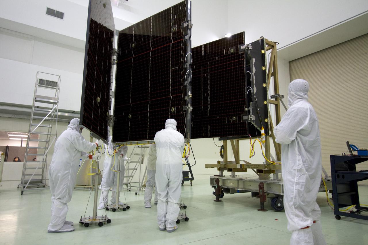 CAPE CANAVERAL, Fla. -- Technicians in the Astrotech payload processing facility in Titusville, Fla., begin to unfurl a solar panel that will help power NASA's Juno spacecraft on a mission to Jupiter. Power-generating panels on three sets of solar arrays will extend outward from Juno’s hexagonal body, giving the overall spacecraft a span of more than 66 feet in order to operate at such a great distance from the sun. Juno is scheduled to launch aboard an Atlas V rocket from Cape Canaveral, Fla., on Aug. 5, 2011, reaching Jupiter in July 2016. The spacecraft will orbit the giant planet more than 30 times, skimming to within 3,000 miles above its cloud tops, for about one year. With its suite of science instruments, the spacecraft will investigate the existence of a solid planetary core, map Jupiter's intense magnetic field, measure the amount of water and ammonia in the deep atmosphere, and observe the planet's auroras. For more information visit, www.nasa.gov/juno. Photo credit: NASA/Jack Pfaller