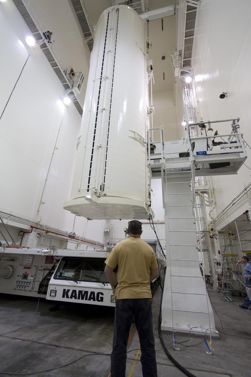CAPE CANAVERAL, Fla. -- After being rotated from a horizontal to vertical position, the canister that contains the Alpha Magnetic Spectrometer-2 AMS and Express Logistics Carrier-3 for space shuttle Endeavour's STS-134 mission is lowered to its transportation vehicle in the Canister Rotation Facility at NASA's Kennedy Space Center in Florida. Endeavour and its six-member STS-134 crew are targeted to lift off April 19 at 7:48 p.m. EDT to deliver the payload to the International Space Station. For more information visit, www.nasa.gov/mission_pages/shuttle/shuttlemissions/sts134/index.html. Photo credit: NASA/Jack Pfaller