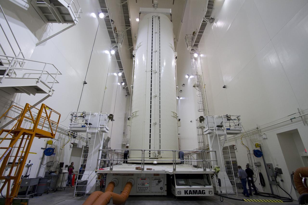 CAPE CANAVERAL, Fla. -- After being rotated from a horizontal to vertical position, the canister that contains the Alpha Magnetic Spectrometer-2 AMS and Express Logistics Carrier-3 for space shuttle Endeavour's STS-134 mission is lowered to its transportation vehicle in the Canister Rotation Facility at NASA's Kennedy Space Center in Florida. Endeavour and its six-member STS-134 crew are targeted to lift off April 19 at 7:48 p.m. EDT to deliver the payload to the International Space Station. For more information visit, www.nasa.gov/mission_pages/shuttle/shuttlemissions/sts134/index.html. Photo credit: NASA/Jack Pfaller