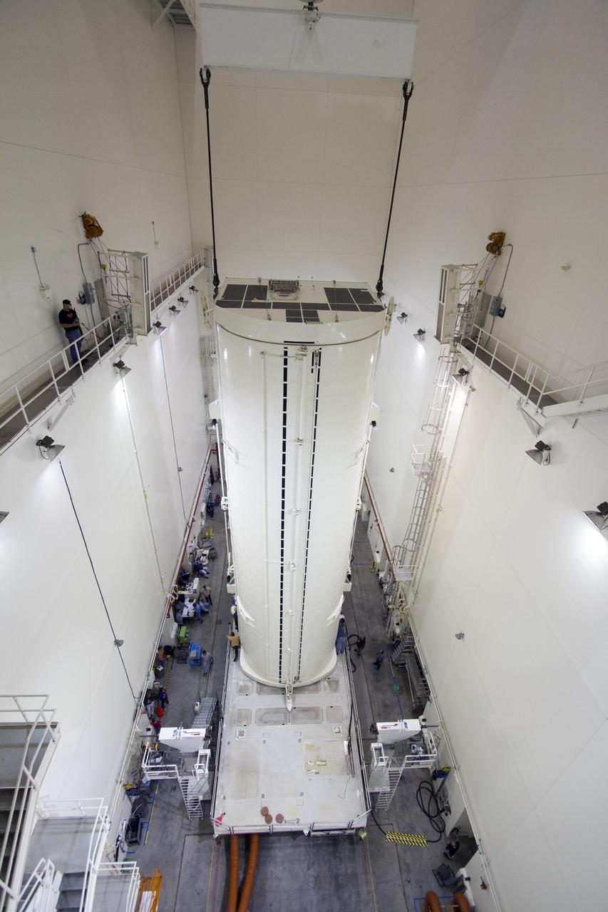 CAPE CANAVERAL, Fla. -- After being rotated from a horizontal to vertical position, the canister that contains the Alpha Magnetic Spectrometer-2 AMS and Express Logistics Carrier-3 for space shuttle Endeavour's STS-134 mission is lowered to its transportation vehicle in the Canister Rotation Facility at NASA's Kennedy Space Center in Florida. Endeavour and its six-member STS-134 crew are targeted to lift off April 19 at 7:48 p.m. EDT to deliver the payload to the International Space Station. For more information visit, www.nasa.gov/mission_pages/shuttle/shuttlemissions/sts134/index.html. Photo credit: NASA/Jack Pfaller