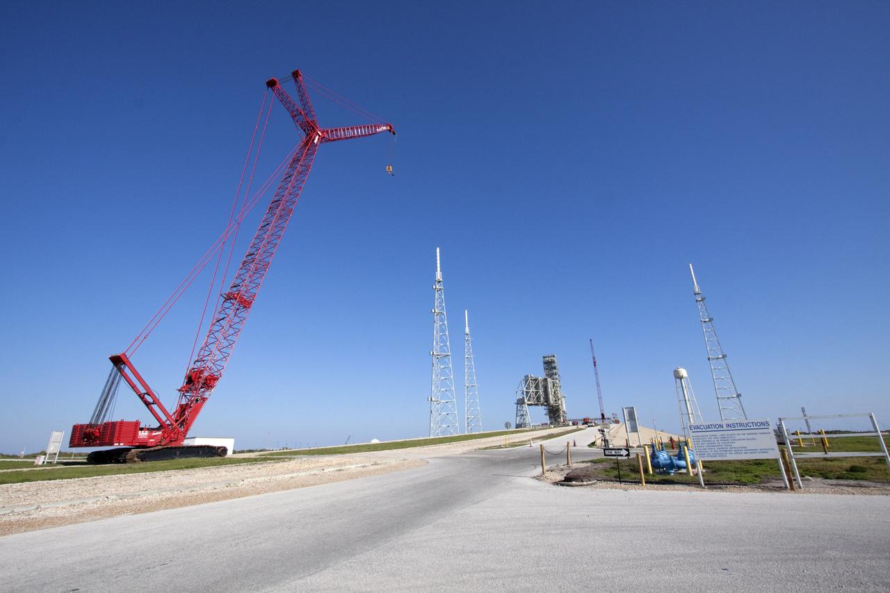 CAPE CANAVERAL, Fla. -- At NASA's Kennedy Space Center in Florida, a large crane makes its way up to the surface of Launch Pad 39B to assist in the removal of the fixed service structure FSS. Removal of the pad's rotating service structure RSS continues. The FSS and RSS were designed to support the unique needs of the Space Shuttle Program. In 2009, the pad was no longer needed for the shuttle program, so it is being restructured for future use.            Its new design will feature a "clean pad" for rockets to come with their own launcher, making it more versatile for a number of vehicles. The transformation also includes the refurbishment of the liquid oxygen and liquid hydrogen tanks and the upgrade of about 1.3 million feet of cable. The new lightning protection system, which was in place for the October 2009 launch of Ares I-X, will remain. For information on NASA's future plans, visit www.nasa.gov. Photo credit: NASA/Troy Cryder