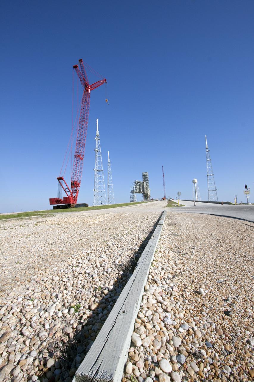 CAPE CANAVERAL, Fla. -- At NASA's Kennedy Space Center in Florida, a large crane makes its way up to the surface of Launch Pad 39B to assist in the removal of the fixed service structure FSS. Removal of the pad's rotating service structure RSS continues. The FSS and RSS were designed to support the unique needs of the Space Shuttle Program. In 2009, the pad was no longer needed for the shuttle program, so it is being restructured for future use.          Its new design will feature a "clean pad" for rockets to come with their own launcher, making it more versatile for a number of vehicles. The transformation also includes the refurbishment of the liquid oxygen and liquid hydrogen tanks and the upgrade of about 1.3 million feet of cable. The new lightning protection system, which was in place for the October 2009 launch of Ares I-X, will remain. For information on NASA's future plans, visit www.nasa.gov. Photo credit: NASA/Troy Cryder