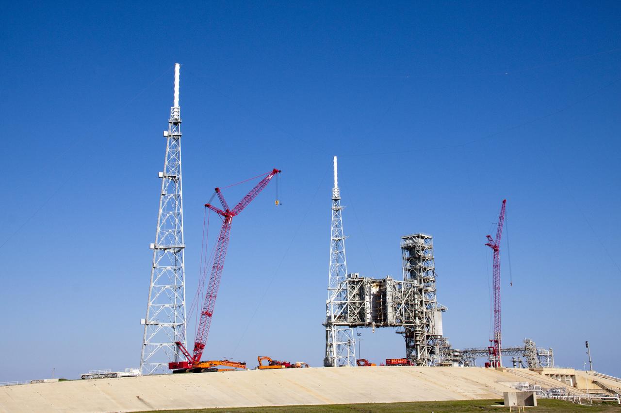 CAPE CANAVERAL, Fla. -- At NASA's Kennedy Space Center in Florida, two large cranes will assist in the removal of Launch Pad 39B's fixed service structure FSS and rotating service structure RSS. The FSS and RSS were designed to support the unique needs of the Space Shuttle Program. In 2009, the pad was no longer needed for the shuttle program, so it is being restructured for future use.        Its new design will feature a "clean pad" for rockets to come with their own launcher, making it more versatile for a number of vehicles. The transformation also includes the refurbishment of the liquid oxygen and liquid hydrogen tanks and the upgrade of about 1.3 million feet of cable. The new lightning protection system, which was in place for the October 2009 launch of Ares I-X, will remain. For information on NASA's future plans, visit www.nasa.gov. Photo credit: NASA/Troy Cryder