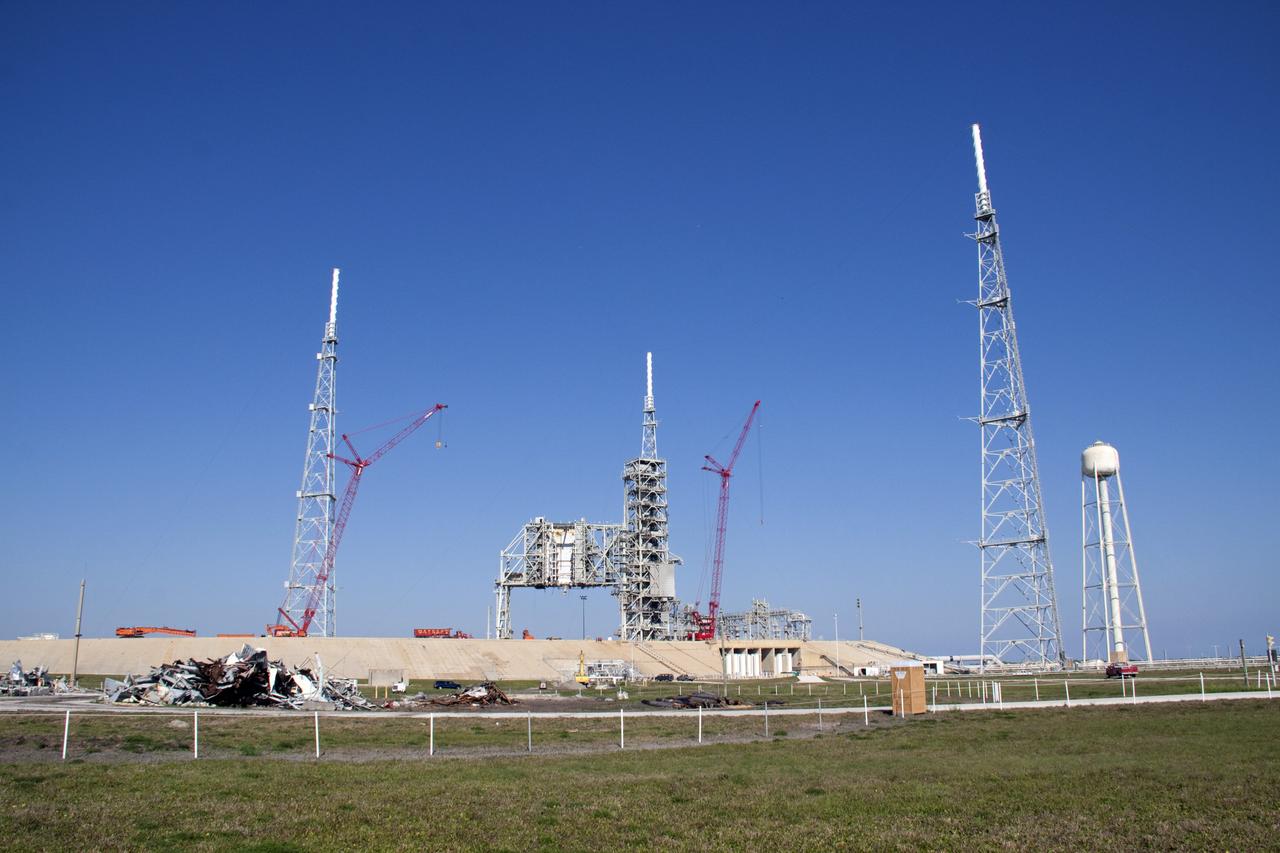 CAPE CANAVERAL, Fla. -- At NASA's Kennedy Space Center in Florida, two large cranes will assist in the removal of Launch Pad 39B's fixed service structure FSS and rotating service structure RSS. The FSS and RSS were designed to support the unique needs of the Space Shuttle Program. In 2009, the pad was no longer needed for the shuttle program, so it is being restructured for future use.    Its new design will feature a "clean pad" for rockets to come with their own launcher, making it more versatile for a number of vehicles. The transformation also includes the refurbishment of the liquid oxygen and liquid hydrogen tanks and the upgrade of about 1.3 million feet of cable. The new lightning protection system, which was in place for the October 2009 launch of Ares I-X, will remain. For information on NASA's future plans, visit www.nasa.gov. Photo credit: NASA/Troy Cryder