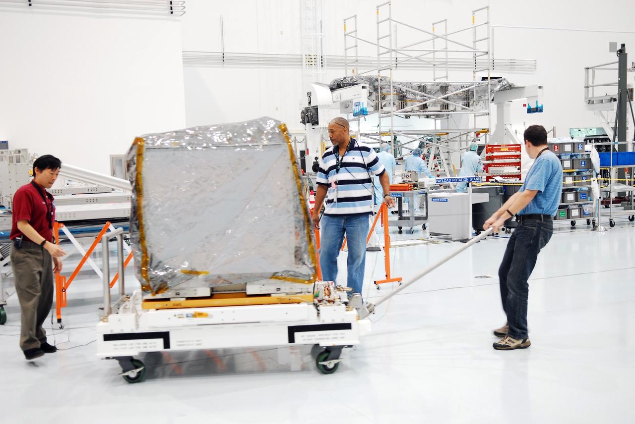 CAPE CANAVERAL, Fla. -- Technicians transport a system that will investigate the potential for robotically refueling existing spacecraft in orbit to a low bay test cell in the Space Station Processing Facility at NASA's Kennedy Space Center in Florida. Called the Robotic Refueling Mission RRM, the system will be processed to fly aboard space shuttle Atlantis on the STS-135 mission to the International Space Station. Atlantis and its STS-135 crew are scheduled to carry the Raffaello multipurpose logistics module packed with supplies, logistics and spare parts to the space station. The mission also will return a failed ammonia pump module to help NASA better understand the failure mechanism and improve pump designs for future systems. STS-135, targeted to launch June 28, will be the 33rd flight of Atlantis, the 37th shuttle mission to the space station, and the 135th and final mission of NASA's Space Shuttle Program. For more information visit, www.nasa.gov/mission_pages/shuttle/shuttlemissions/sts135/index.html. Photo credit: NASA/Jim Grossmann