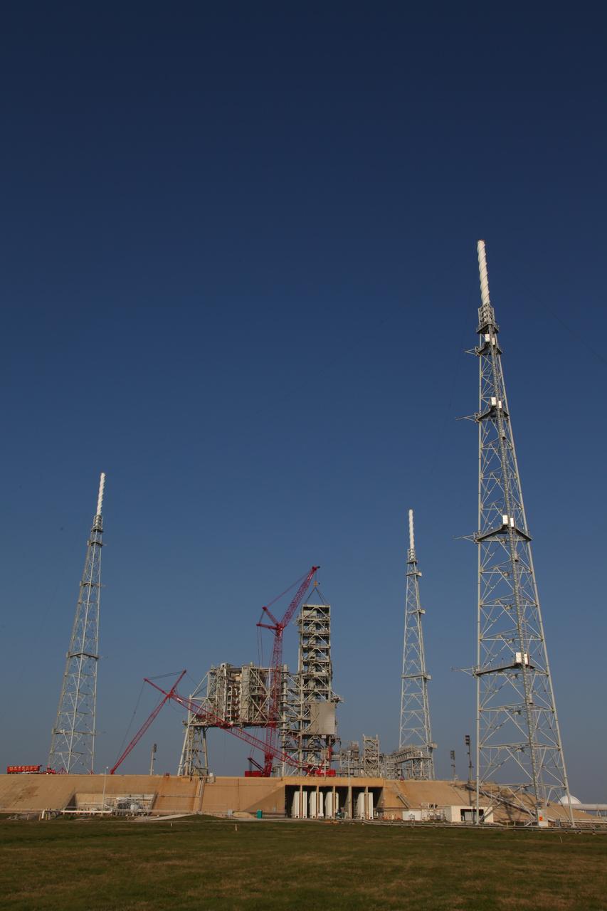 CAPE CANAVERAL, Fla. -- A large crane dismantles the fixed service structure FSS piece by piece on Launch Pad 39B at NASA's Kennedy Space Center in Florida. Work to remove the rotating service structure RSS also continues at the pad. The FSS and RSS were designed to support the unique needs of the Space Shuttle Program. In 2009, the pad was no longer needed for the shuttle program, so it is being restructured for future use.    Its new design will feature a "clean pad" for rockets to come with their own launcher, making it more versatile for a number of vehicles. The transformation also includes the refurbishment of the liquid oxygen and liquid hydrogen tanks and the upgrade of about 1.3 million feet of cable. The new lightning protection system, which was in place for the October 2009 launch of Ares I-X, will remain. For information on NASA's future plans, visit www.nasa.gov. Photo credit: NASA/Frankie Martin