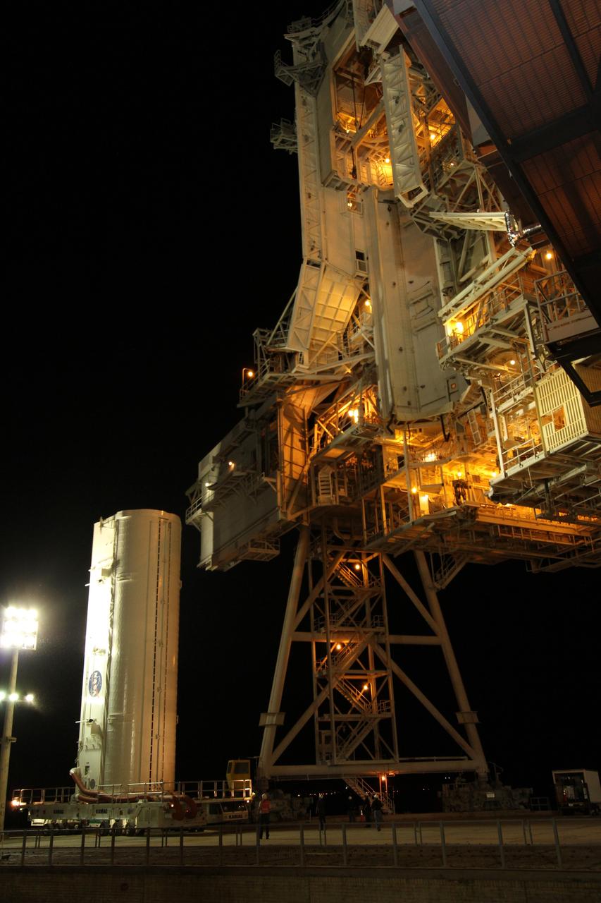 CAPE CANAVERAL, Fla. -- A canister, carrying the Alpha Magnetic Spectrometer-2 (AMS) and Express Logistics Carrier-3 for space shuttle Endeavour's STS-134 mission, arrives at Launch Pad 39A at NASA's Kennedy Space Center in Florida. Next, crews at the pad will move the payload into the Payload Ground Handling Mechanism (PGHM), and the rotating service structure (RSS) that protects the shuttle from the elements and provides access to its components will be rotated back into place. The payload is scheduled to be installed into the shuttle's cargo bay March 25. Endeavour and its six-member STS-134 crew are targeted to lift off April 19 at 7:48 p.m. EDT to deliver the payload to the International Space Station. This is Endeavour's final scheduled mission. For more information visit, www.nasa.gov/mission_pages/shuttle/shuttlemissions/sts134/index.html. Photo credit: NASA/Cory Huston