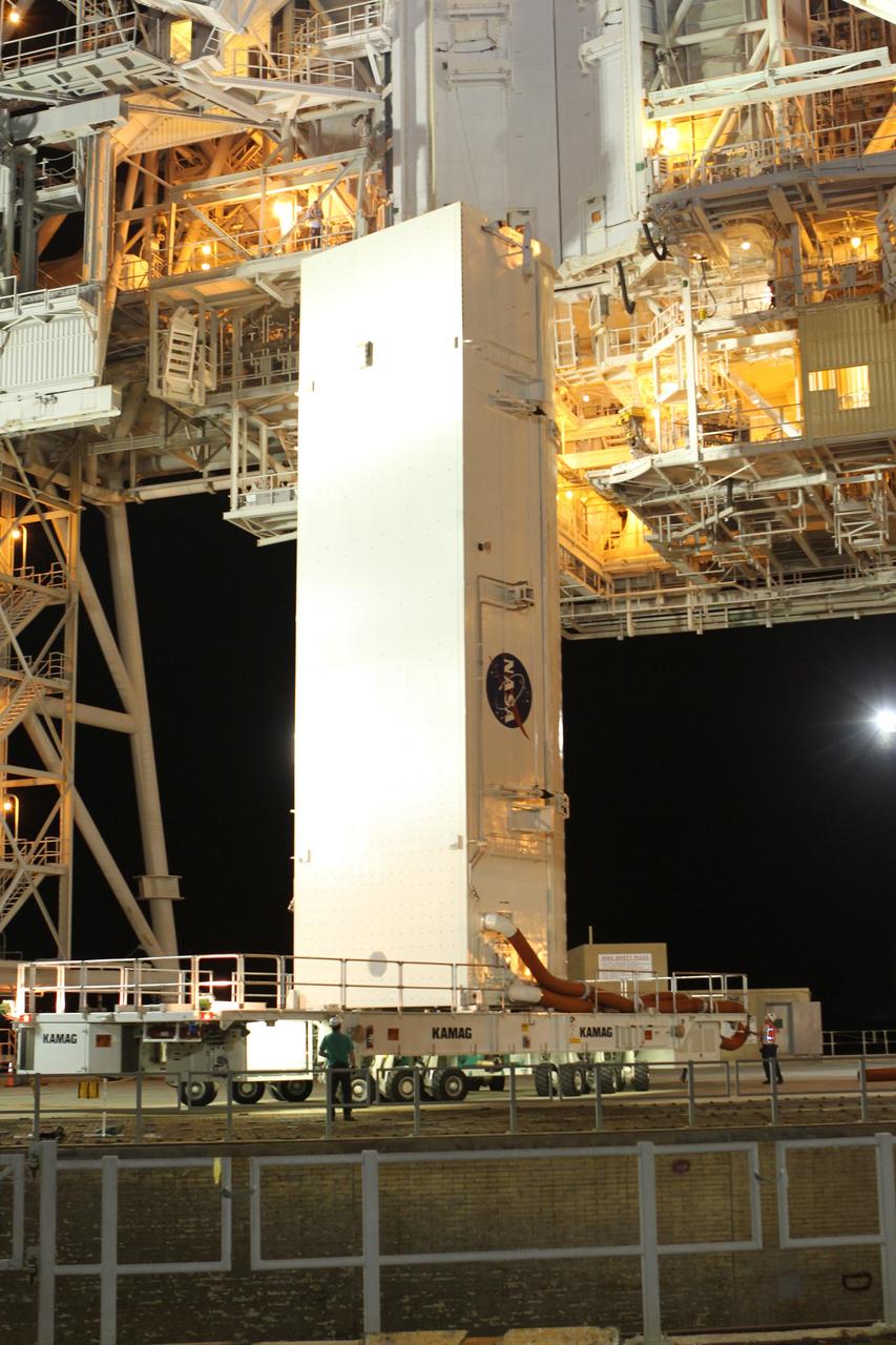 CAPE CANAVERAL, Fla. -- A canister, carrying the Alpha Magnetic Spectrometer-2 (AMS) and Express Logistics Carrier-3 for space shuttle Endeavour's STS-134 mission, arrives at Launch Pad 39A at NASA's Kennedy Space Center in Florida. Next, crews at the pad will move the payload into the Payload Ground Handling Mechanism (PGHM), and the rotating service structure (RSS) that protects the shuttle from the elements and provides access to its components will be rotated back into place. The payload is scheduled to be installed into the shuttle's cargo bay March 25. Endeavour and its six-member STS-134 crew are targeted to lift off April 19 at 7:48 p.m. EDT to deliver the payload to the International Space Station. This is Endeavour's final scheduled mission. For more information visit, www.nasa.gov/mission_pages/shuttle/shuttlemissions/sts134/index.html. Photo credit: NASA/Cory Huston