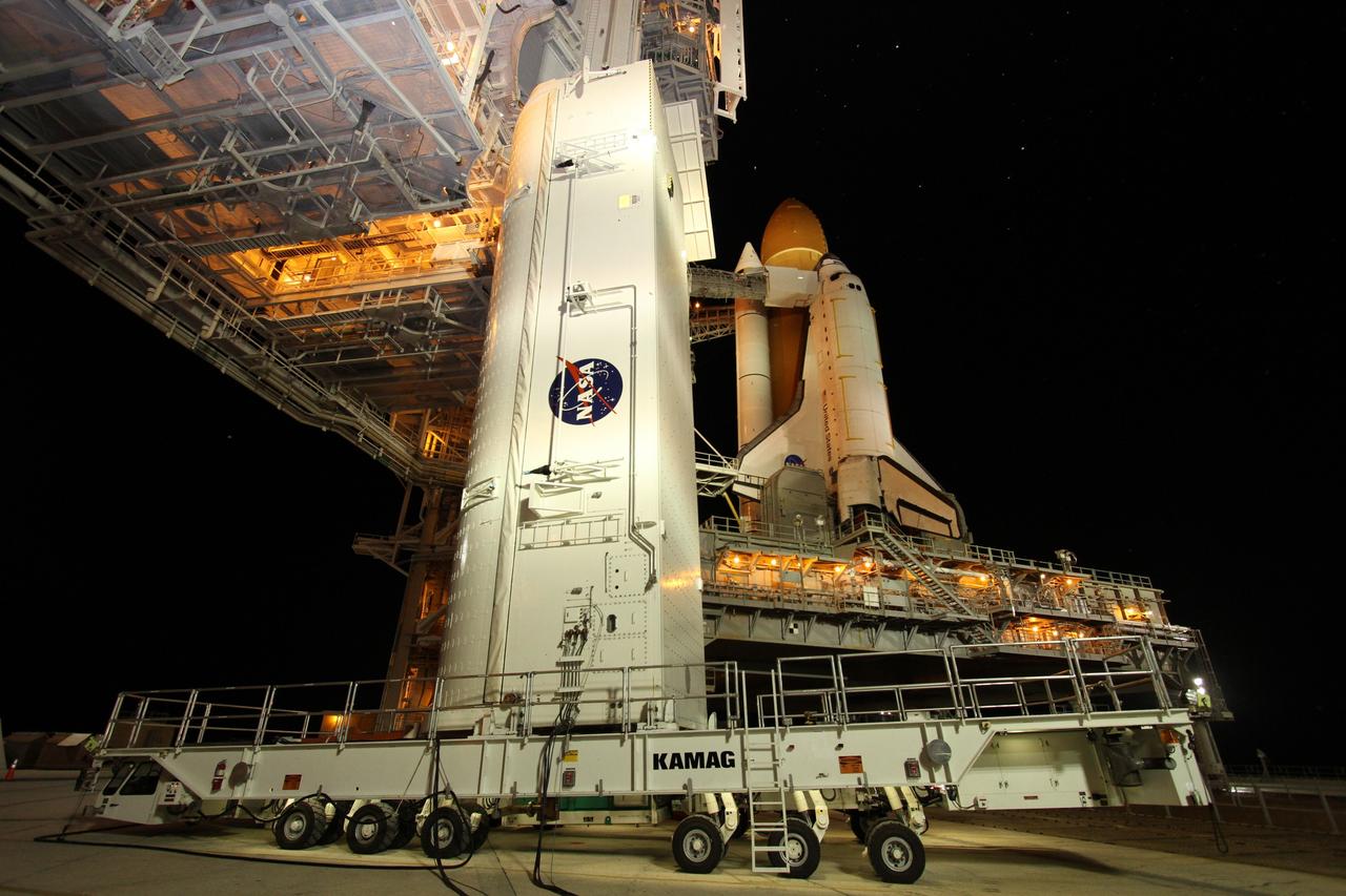 CAPE CANAVERAL, Fla. -- A canister, carrying the Alpha Magnetic Spectrometer-2 (AMS) and Express Logistics Carrier-3 for space shuttle Endeavour's STS-134 mission, arrives at Launch Pad 39A at NASA's Kennedy Space Center in Florida. Next, crews at the pad will move the payload into the Payload Ground Handling Mechanism (PGHM), and the rotating service structure (RSS) that protects the shuttle from the elements and provides access to its components will be rotated back into place. The payload is scheduled to be installed into the shuttle's cargo bay March 25. Endeavour and its six-member STS-134 crew are targeted to lift off April 19 at 7:48 p.m. EDT to deliver the payload to the International Space Station. This is Endeavour's final scheduled mission. For more information visit, www.nasa.gov/mission_pages/shuttle/shuttlemissions/sts134/index.html. Photo credit: NASA/Cory Huston