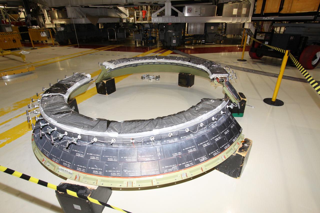 CAPE CANAVERAL, Fla. - Crews in Orbiter Processing Facility-2 at NASA's Kennedy Space Center in Florida remove space shuttle Discovery's right-hand inner heat shield from engine No. 1. The removal is part of Discovery's transition and retirement processing. Work performed on Discovery is expected to help rocket designers build next-generation spacecraft and prepare the shuttle for future public display.Photo credit: NASA/Jack Pfaller