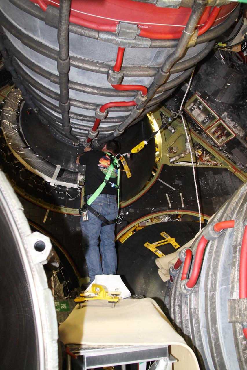 CAPE CANAVERAL, Fla. - Crews in Orbiter Processing Facility-2 at NASA's Kennedy Space Center in Florida remove space shuttle Discovery's right-hand inner heat shield from engine No. 1. The removal is part of Discovery's transition and retirement processing. Work performed on Discovery is expected to help rocket designers build next-generation spacecraft and prepare the shuttle for future public display.Photo credit: NASA/Jack Pfaller