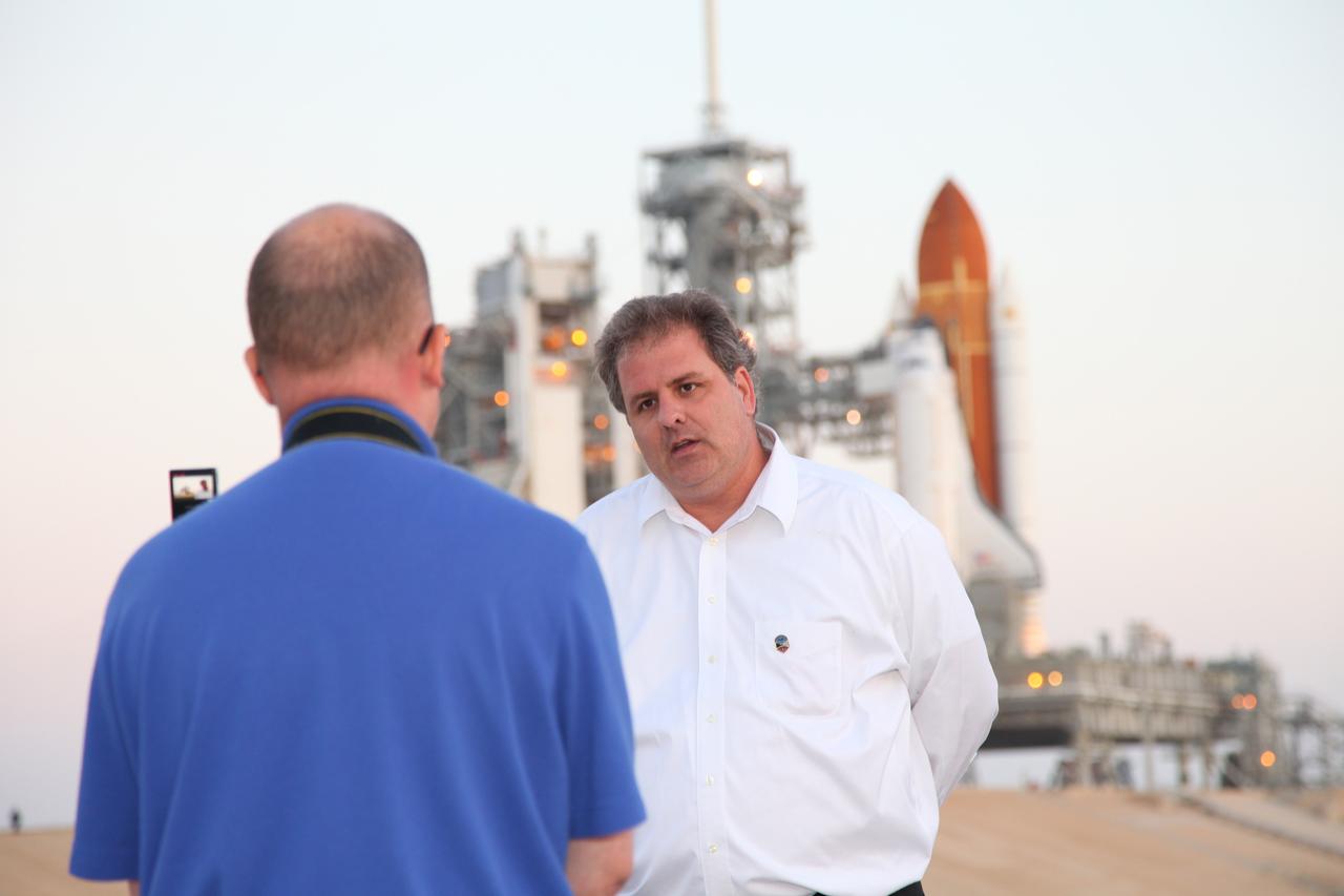 CAPE CANAVERAL, Fla. -- STS-134 Payloads Mission Manager Joe Delai talks to media with space shuttle Endeavour and its primary payload in the background on Launch Pad 39A at NASA's Kennedy Space Center in Florida. The Alpha Magnetic Spectrometer-2 (AMS) and Express Logistics Carrier-3 are scheduled to be installed into the shuttle's cargo bay March 25.        Endeavour and its six-member STS-134 crew are targeted to lift off April 19 at 7:48 p.m. EDT to deliver the payload to the International Space Station. This is Endeavour's final scheduled mission. For more information visit, www.nasa.gov/mission_pages/shuttle/shuttlemissions/sts134/index.html. Photo credit: NASA/Frankie Martin