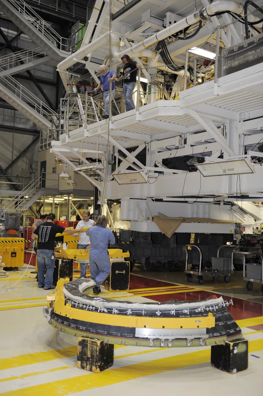 CAPE CANAVERAL, Fla. - Crews in Orbiter Processing Facility-2 at NASA's Kennedy Space Center in Florida remove space shuttle Discovery's right-hand inner heat shield from engine No. 1. The removal is part of Discovery's transition and retirement processing. Work performed on Discovery is expected to help rocket designers build next-generation spacecraft and prepare the shuttle for future public display.Photo credit: NASA/Kim Shiflett