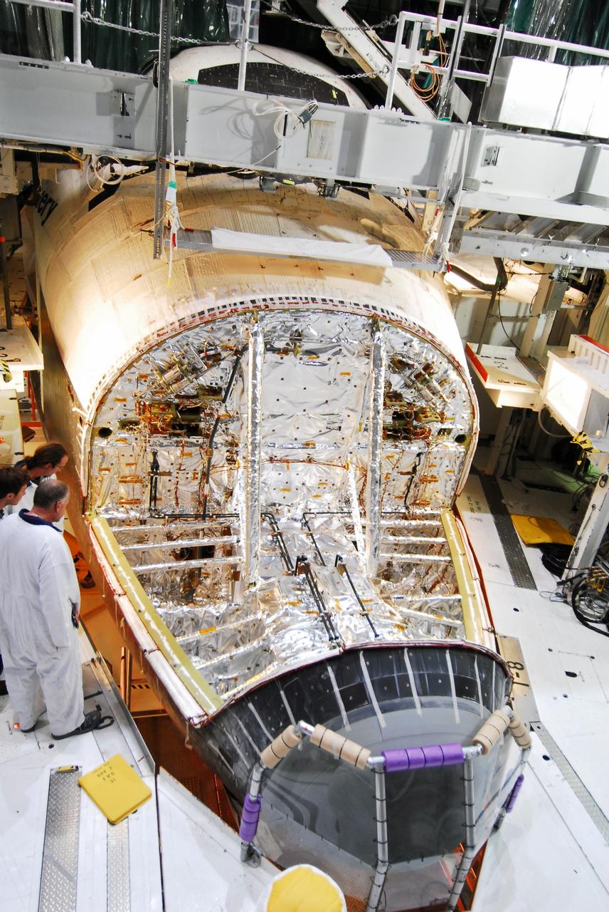 CAPE CANAVERAL, Fla. - Space shuttle Discovery's forward reaction control system (FRCS), which helped steer the shuttle in orbit, is removed in Orbiter Processing Facility-2 at NASA's Kennedy Space Center in Florida. To maneuver, the FRCS used hypergolic fuel and oxidizer, which were purged from Discovery after its final spaceflight, STS-133. Next, the FRCS will be shipped to a maintenance facility at White Sands Space Harbor in New Mexico, where additional inspections will be performed and its components made safe to go on public display. The transition and retirement processing is expected to help rocket designers build next-generation spacecraft and prepare the shuttle for display.            Photo credit: NASA/Jim Grossmann