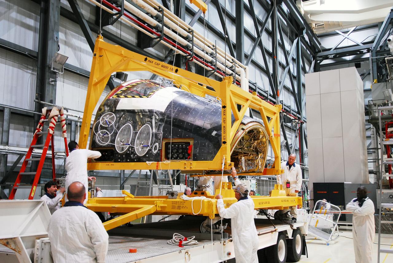 CAPE CANAVERAL, Fla. - Space shuttle Discovery's forward reaction control system (FRCS), which helped steer the shuttle in orbit, is moved to a transporter in Orbiter Processing Facility-2 at NASA's Kennedy Space Center in Florida. To maneuver, the FRCS used hypergolic fuel and oxidizer, which were purged from Discovery after its final spaceflight, STS-133. Next, the FRCS will be shipped to a maintenance facility at White Sands Space Harbor in New Mexico, where additional inspections will be performed and its components made safe to go on public display. The transition and retirement processing is expected to help rocket designers build next-generation spacecraft and prepare the shuttle for display.        Photo credit: NASA/Jim Grossmann