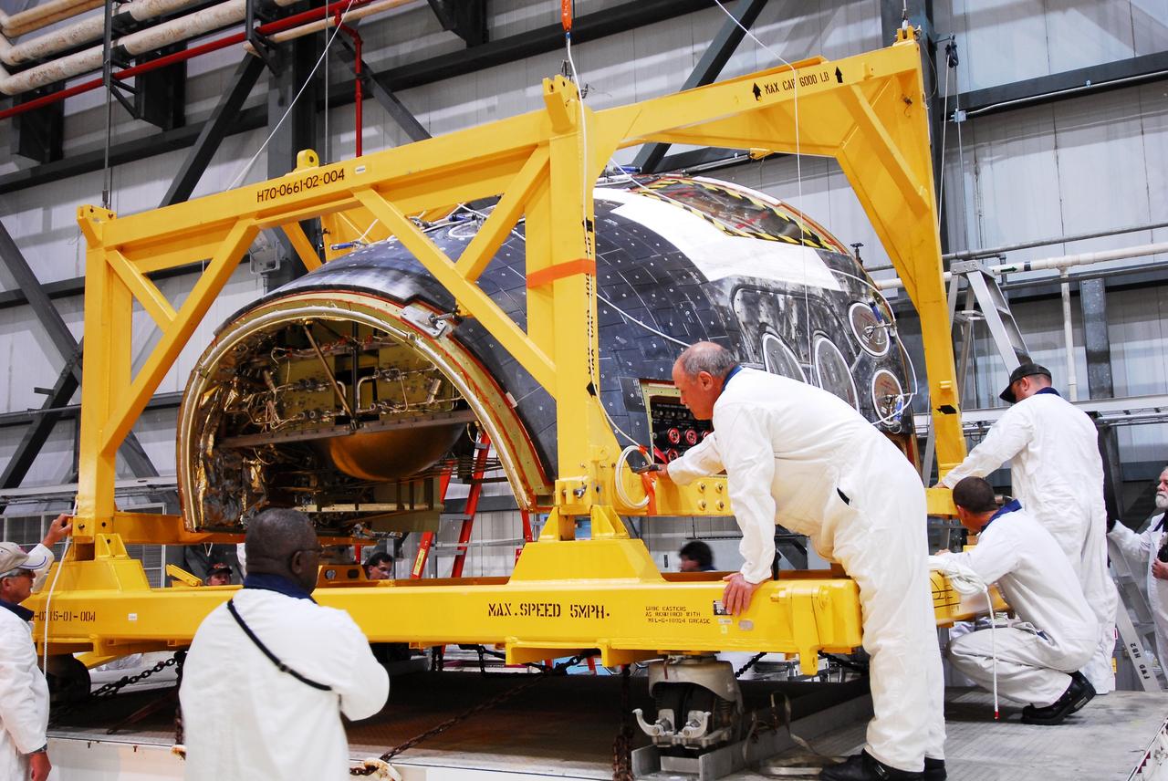 CAPE CANAVERAL, Fla. - Space shuttle Discovery's forward reaction control system (FRCS), which helped steer the shuttle in orbit, is moved to a transporter in Orbiter Processing Facility-2 at NASA's Kennedy Space Center in Florida. To maneuver, the FRCS used hypergolic fuel and oxidizer, which were purged from Discovery after its final spaceflight, STS-133. Next, the FRCS will be shipped to a maintenance facility at White Sands Space Harbor in New Mexico, where additional inspections will be performed and its components made safe to go on public display. The transition and retirement processing is expected to help rocket designers build next-generation spacecraft and prepare the shuttle for display.      Photo credit: NASA/Jim Grossmann