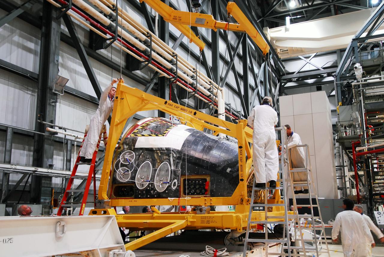 CAPE CANAVERAL, Fla. - Space shuttle Discovery's forward reaction control system (FRCS), which helped steer the shuttle in orbit, is moved to a transporter in Orbiter Processing Facility-2 at NASA's Kennedy Space Center in Florida. To maneuver, the FRCS used hypergolic fuel and oxidizer, which were purged from Discovery after its final spaceflight, STS-133. Next, the FRCS will be shipped to a maintenance facility at White Sands Space Harbor in New Mexico, where additional inspections will be performed and its components made safe to go on public display. The transition and retirement processing is expected to help rocket designers build next-generation spacecraft and prepare the shuttle for display.    Photo credit: NASA/Jim Grossmann