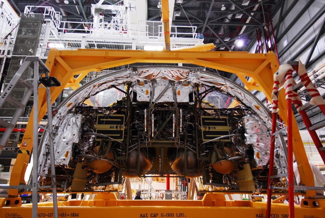 CAPE CANAVERAL, Fla. - Space shuttle Discovery's forward reaction control system (FRCS), which helped steer the shuttle in orbit, is atop a transporter in Orbiter Processing Facility-2 at NASA's Kennedy Space Center in Florida. To maneuver, the FRCS used hypergolic fuel and oxidizer, which were purged from Discovery after its final spaceflight, STS-133. Next, the FRCS will be shipped to a maintenance facility at White Sands Space Harbor in New Mexico, where additional inspections will be performed and its components made safe to go on public display. The transition and retirement processing is expected to help rocket designers build next-generation spacecraft and prepare the shuttle for display.      Photo credit: NASA/Jim Grossmann