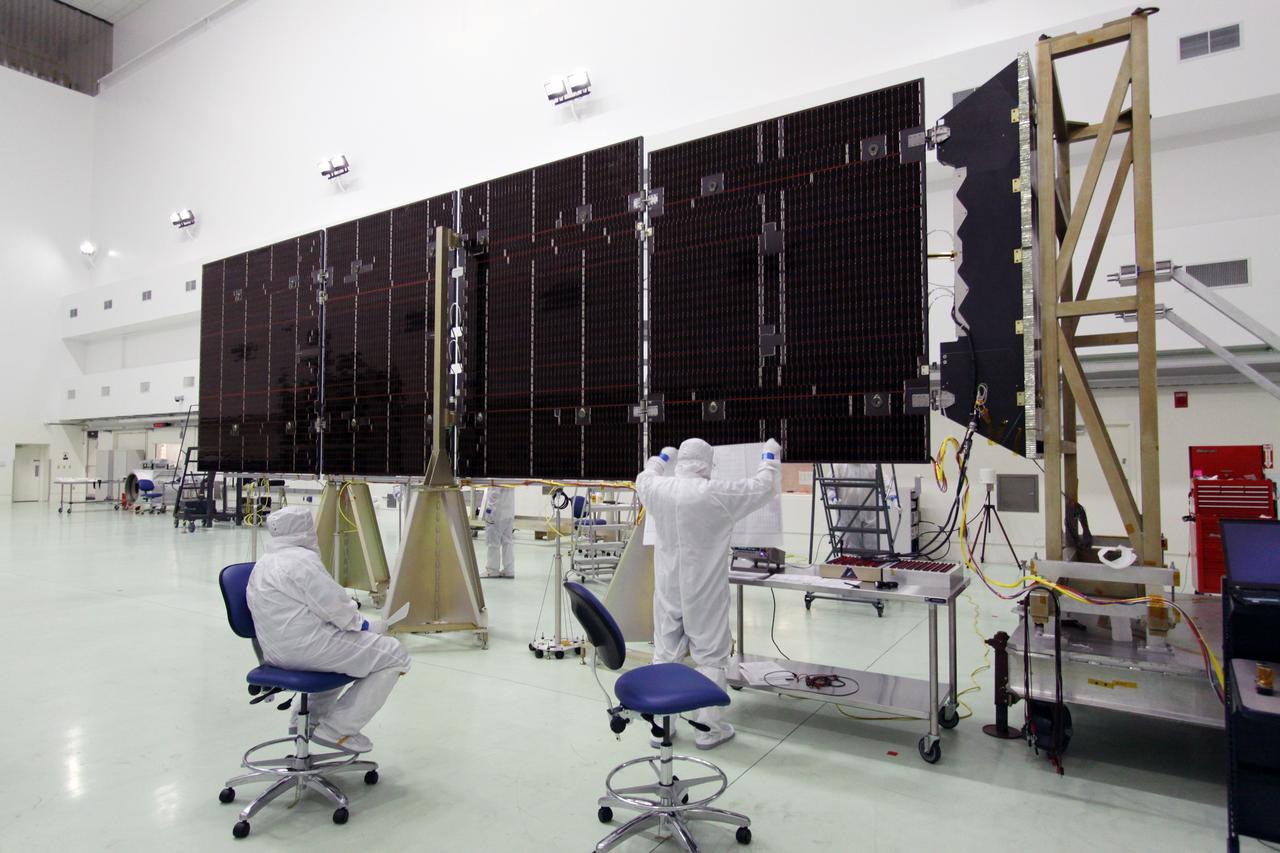 CAPE CANAVERAL, Fla. -- Technicians in the Astrotech payload processing facility in Titusville, Fla., prepare to test the electrical continuity of a solar array that will help power NASA's Juno spacecraft on a mission to Jupiter. Power-generating panels on three sets of solar arrays will extend outward from Juno’s hexagonal body, giving the overall spacecraft a span of more than 66 feet in order to operate at such a great distance from the sun. Juno is scheduled to launch aboard an Atlas V rocket from Cape Canaveral, Fla., on Aug. 5, 2011, reaching Jupiter in July 2016. The spacecraft will orbit the giant planet more than 30 times, skimming to within 3,000 miles above its cloud tops, for about one year. With its suite of science instruments, the spacecraft will investigate the existence of a solid planetary core, map Jupiter's intense magnetic field, measure the amount of water and ammonia in the deep atmosphere, and observe the planet's auroras. For more information visit, www.nasa.gov/juno. Photo credit: NASA/Jack Pfaller