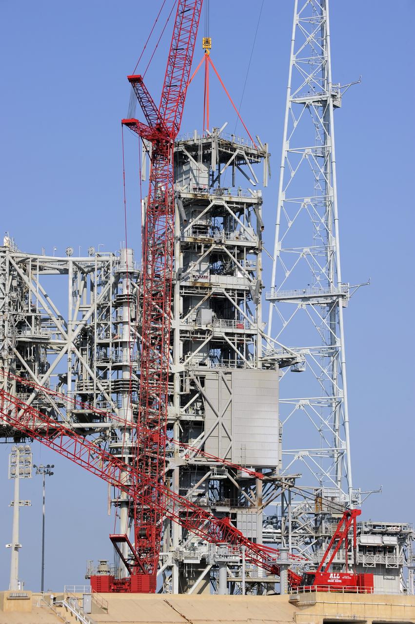 CAPE CANAVERAL, Fla. -- A large crane dismantles another level of the fixed service structure (FSS) on Launch Pad 39B at NASA's Kennedy Space Center in Florida. Work to remove the rotating service structure (RSS) also continues at the pad. The FSS and RSS were designed to support the unique needs of the Space Shuttle Program. In 2009, the pad was no longer needed for the shuttle program, so it is being restructured for future use.            Its new design will feature a "clean pad" for rockets to come with their own launcher, making it more versatile for a number of vehicles. The transformation also includes the refurbishment of the liquid oxygen and liquid hydrogen tanks and the upgrade of about 1.3 million feet of cable. The new lightning protection system, which was in place for the October 2009 launch of Ares I-X, will remain. For information on NASA's future plans, visit www.nasa.gov. Photo credit: NASA/Kim Shiflett