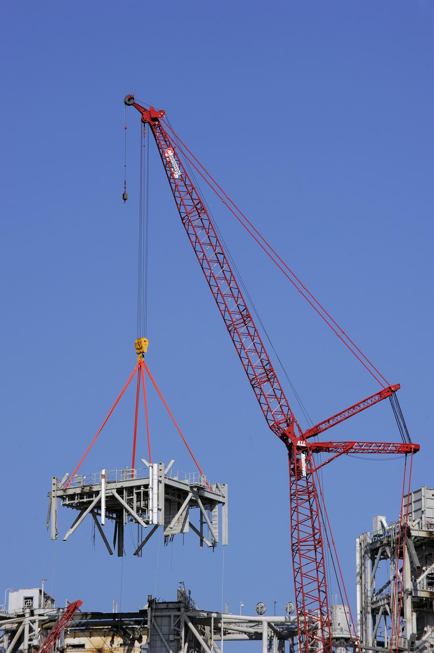 CAPE CANAVERAL, Fla. -- A large crane dismantles another level of the fixed service structure (FSS) on Launch Pad 39B at NASA's Kennedy Space Center in Florida. Work to remove the rotating service structure (RSS) also continues at the pad. The FSS and RSS were designed to support the unique needs of the Space Shuttle Program. In 2009, the pad was no longer needed for the shuttle program, so it is being restructured for future use.            Its new design will feature a "clean pad" for rockets to come with their own launcher, making it more versatile for a number of vehicles. The transformation also includes the refurbishment of the liquid oxygen and liquid hydrogen tanks and the upgrade of about 1.3 million feet of cable. The new lightning protection system, which was in place for the October 2009 launch of Ares I-X, will remain. For information on NASA's future plans, visit www.nasa.gov. Photo credit: NASA/Kim Shiflett
