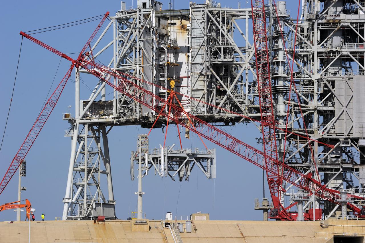 CAPE CANAVERAL, Fla. -- A large crane dismantles another level of the fixed service structure (FSS) on Launch Pad 39B at NASA's Kennedy Space Center in Florida. Work to remove the rotating service structure (RSS) also continues at the pad. The FSS and RSS were designed to support the unique needs of the Space Shuttle Program. In 2009, the pad was no longer needed for the shuttle program, so it is being restructured for future use.            Its new design will feature a "clean pad" for rockets to come with their own launcher, making it more versatile for a number of vehicles. The transformation also includes the refurbishment of the liquid oxygen and liquid hydrogen tanks and the upgrade of about 1.3 million feet of cable. The new lightning protection system, which was in place for the October 2009 launch of Ares I-X, will remain. For information on NASA's future plans, visit www.nasa.gov. Photo credit: NASA/Kim Shiflett