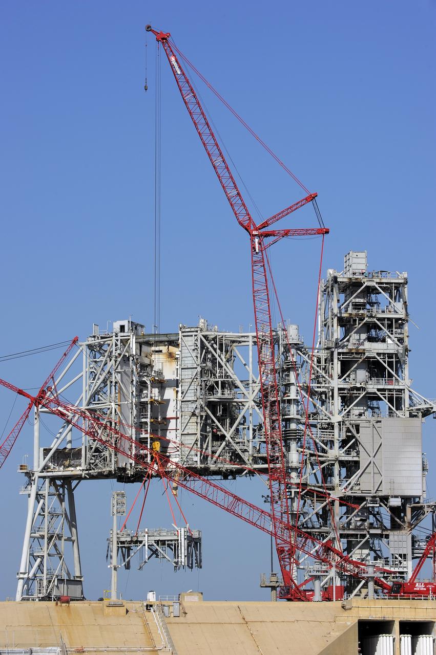 CAPE CANAVERAL, Fla. -- A large crane dismantles another level of the fixed service structure (FSS) on Launch Pad 39B at NASA's Kennedy Space Center in Florida. Work to remove the rotating service structure (RSS) also continues at the pad. The FSS and RSS were designed to support the unique needs of the Space Shuttle Program. In 2009, the pad was no longer needed for the shuttle program, so it is being restructured for future use.            Its new design will feature a "clean pad" for rockets to come with their own launcher, making it more versatile for a number of vehicles. The transformation also includes the refurbishment of the liquid oxygen and liquid hydrogen tanks and the upgrade of about 1.3 million feet of cable. The new lightning protection system, which was in place for the October 2009 launch of Ares I-X, will remain. For information on NASA's future plans, visit www.nasa.gov. Photo credit: NASA/Kim Shiflett