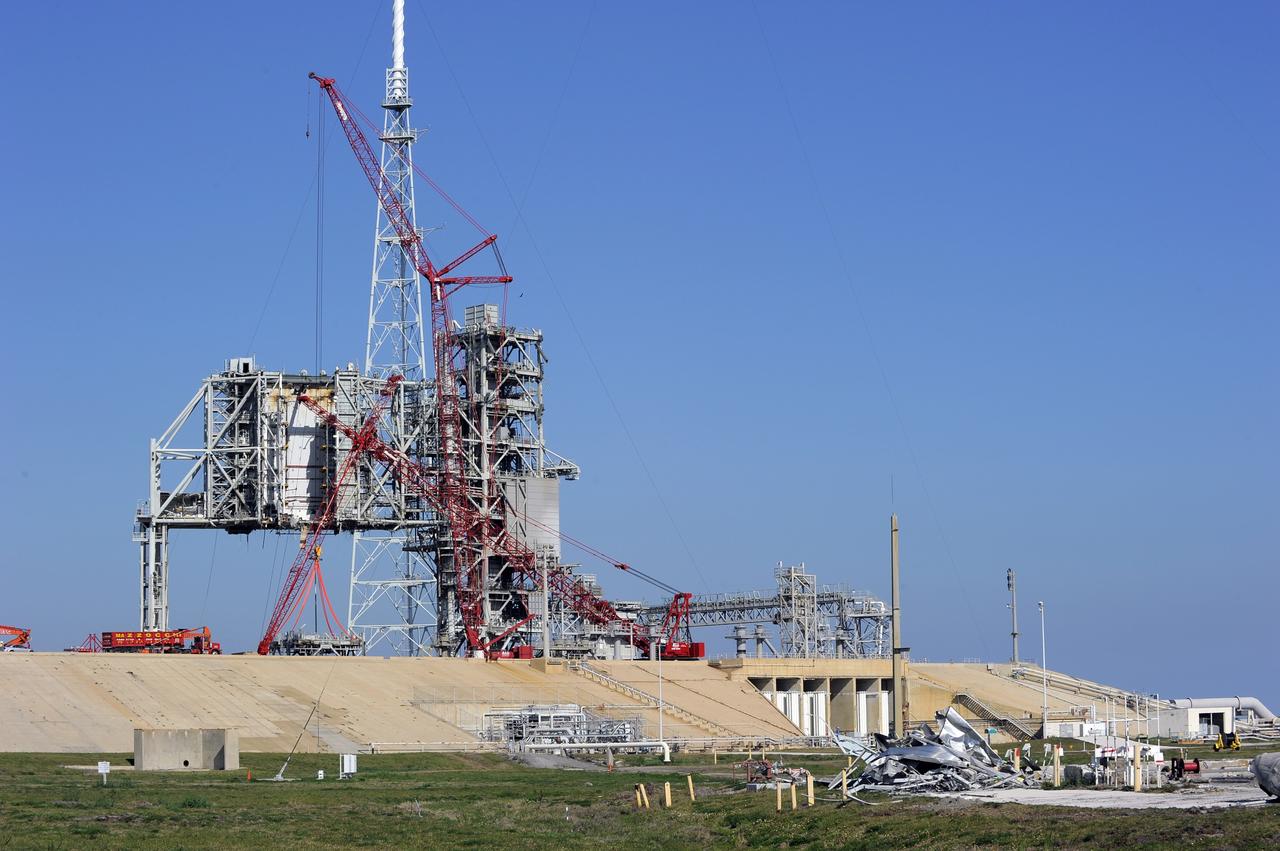 CAPE CANAVERAL, Fla. -- A large crane dismantles another level of the fixed service structure (FSS) on Launch Pad 39B at NASA's Kennedy Space Center in Florida. Work to remove the rotating service structure (RSS) also continues at the pad. The FSS and RSS were designed to support the unique needs of the Space Shuttle Program. In 2009, the pad was no longer needed for the shuttle program, so it is being restructured for future use.            Its new design will feature a "clean pad" for rockets to come with their own launcher, making it more versatile for a number of vehicles. The transformation also includes the refurbishment of the liquid oxygen and liquid hydrogen tanks and the upgrade of about 1.3 million feet of cable. The new lightning protection system, which was in place for the October 2009 launch of Ares I-X, will remain. For information on NASA's future plans, visit www.nasa.gov. Photo credit: NASA/Kim Shiflett