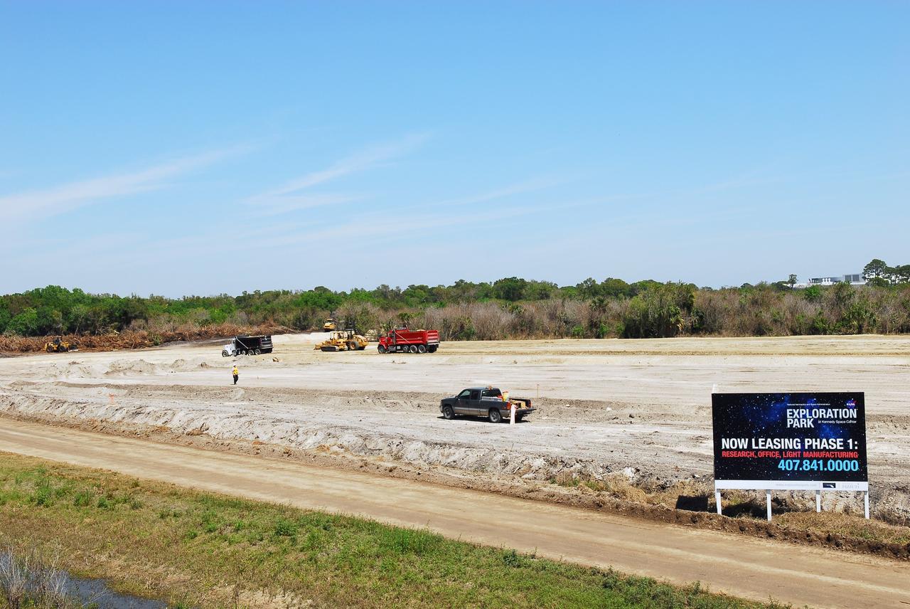 CAPE CANAVERAL, Fla. -- Crews continue to clear land and prepare for the construction of a new road at the Exploration Park site near the Space Life Sciences Laboratory (SLSL) at NASA's Kennedy Space Center in Florida. The first phase will encompass 60 acres just outside Kennedy’s security gates. Nine buildings will provide 350,000-square feet of work space, including educational, office, research and lab, and high-bay facilities. Each building is expected to be certified in the U.S. Green Building Council’s Leadership in Environmental and Energy Design (LEED).      Exploration Park is designed to be a strategically located complex, adjacent to the SLSL, for servicing diverse tenants and uses that will engage in activities to support space-related activities of NASA, other government agencies and the U.S. commercial space industry. It also is expected to bring new aerospace work to the Space Coast. The SLSL will be the anchor facility for the park, which is expected to open its first new facility in early 2012. Photo credit: NASA/Jim Grossmann