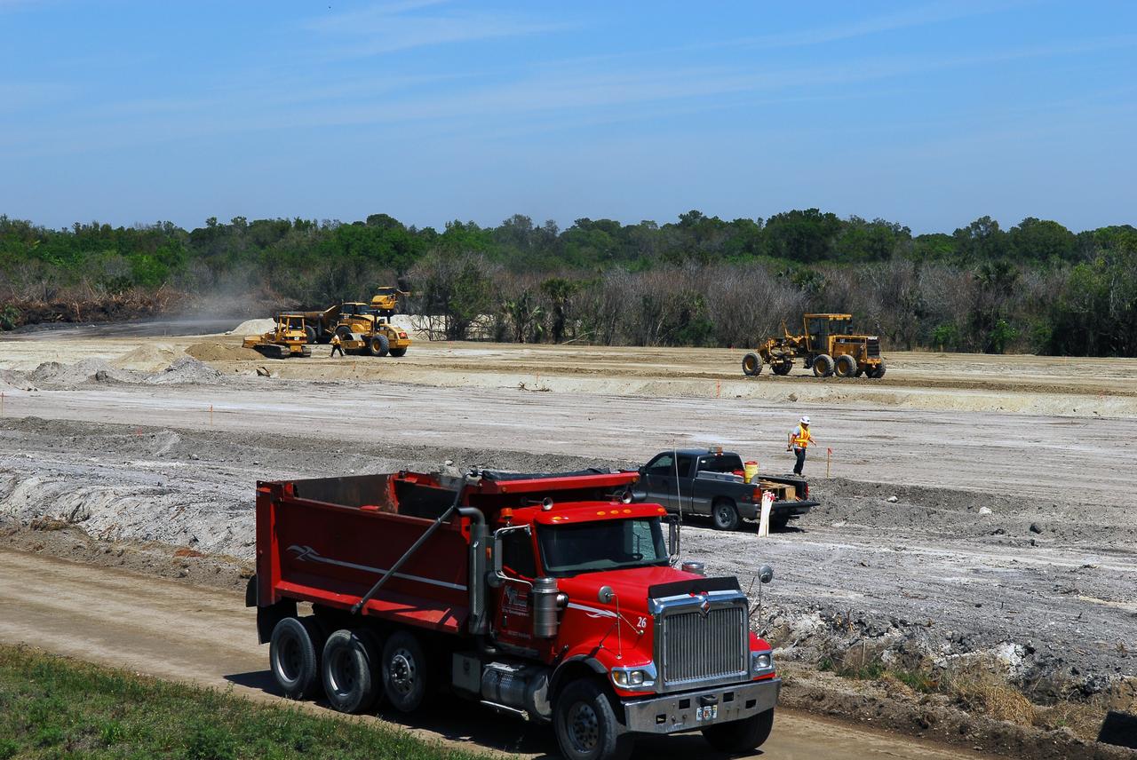 CAPE CANAVERAL, Fla. -- Crews continue to clear land and prepare for the construction of a new road at the Exploration Park site near the Space Life Sciences Laboratory (SLSL) at NASA's Kennedy Space Center in Florida. The first phase will encompass 60 acres just outside Kennedy’s security gates. Nine buildings will provide 350,000-square feet of work space, including educational, office, research and lab, and high-bay facilities. Each building is expected to be certified in the U.S. Green Building Council’s Leadership in Environmental and Energy Design (LEED).      Exploration Park is designed to be a strategically located complex, adjacent to the SLSL, for servicing diverse tenants and uses that will engage in activities to support space-related activities of NASA, other government agencies and the U.S. commercial space industry. It also is expected to bring new aerospace work to the Space Coast. The SLSL will be the anchor facility for the park, which is expected to open its first new facility in early 2012. Photo credit: NASA/Jim Grossmann