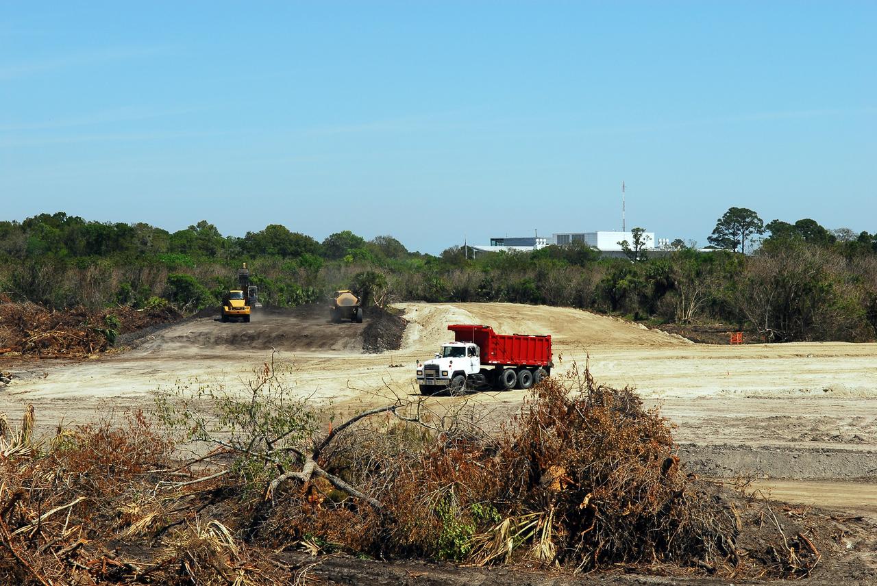 CAPE CANAVERAL, Fla. -- Crews continue to clear land and prepare for the construction of a new road at the Exploration Park site near the Space Life Sciences Laboratory (SLSL) at NASA's Kennedy Space Center in Florida. The first phase will encompass 60 acres just outside Kennedy’s security gates. Nine buildings will provide 350,000-square feet of work space, including educational, office, research and lab, and high-bay facilities. Each building is expected to be certified in the U.S. Green Building Council’s Leadership in Environmental and Energy Design (LEED).      Exploration Park is designed to be a strategically located complex, adjacent to the SLSL, for servicing diverse tenants and uses that will engage in activities to support space-related activities of NASA, other government agencies and the U.S. commercial space industry. It also is expected to bring new aerospace work to the Space Coast. The SLSL will be the anchor facility for the park, which is expected to open its first new facility in early 2012. Photo credit: NASA/Jim Grossmann